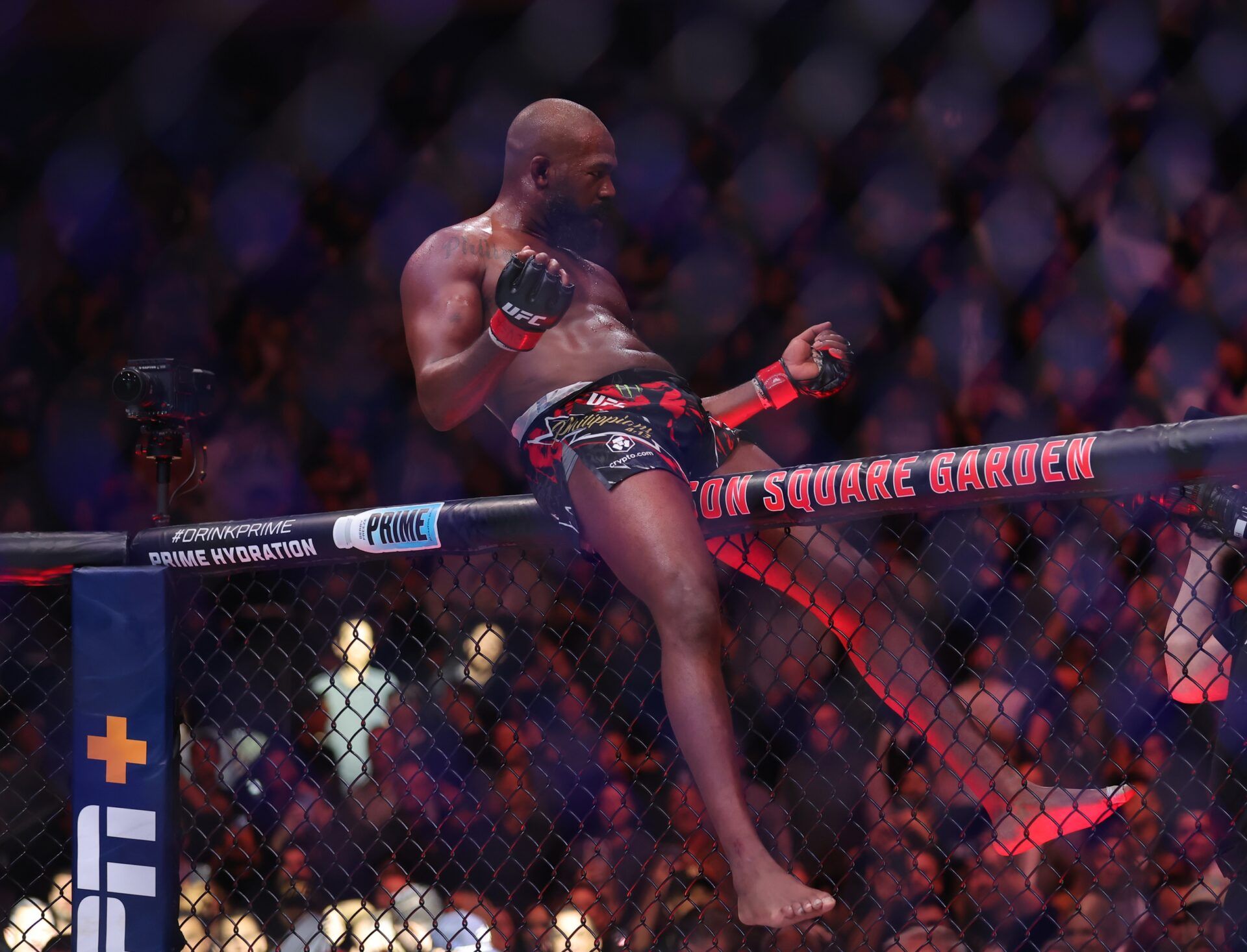 Jon Jones (red gloves) celebrates defeating Stipe Miocoic (blue gloves) in the heavyweight bout during UFC 309 at Madison Square Garden.