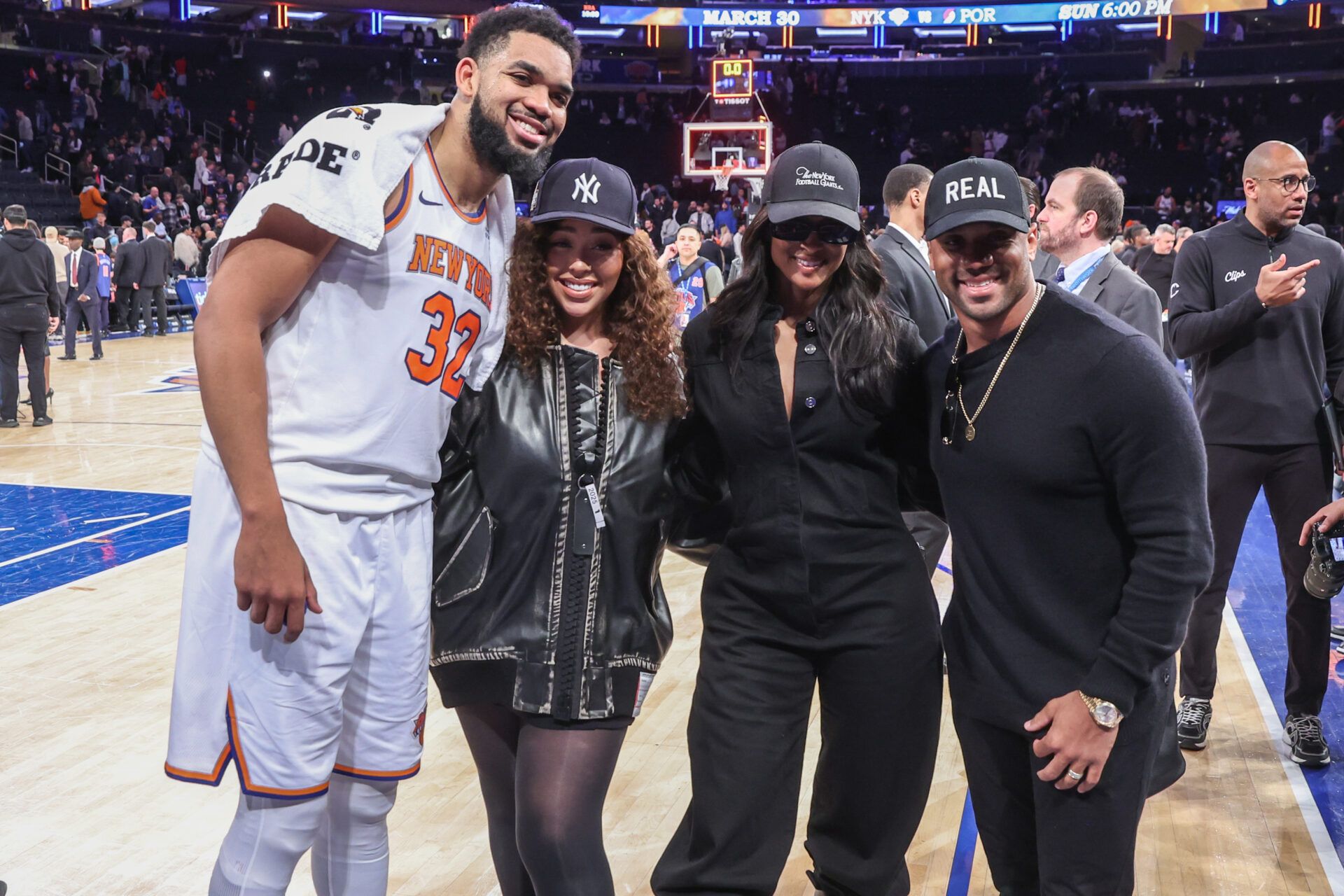 New York Knicks center Karl-Anthony Towns (32) poses for a photo with model Jordyn Woods, singer Ciara, and New York Giants quarterback Russell Wilson following the game against the LA Clippers at Madison Square Garden.