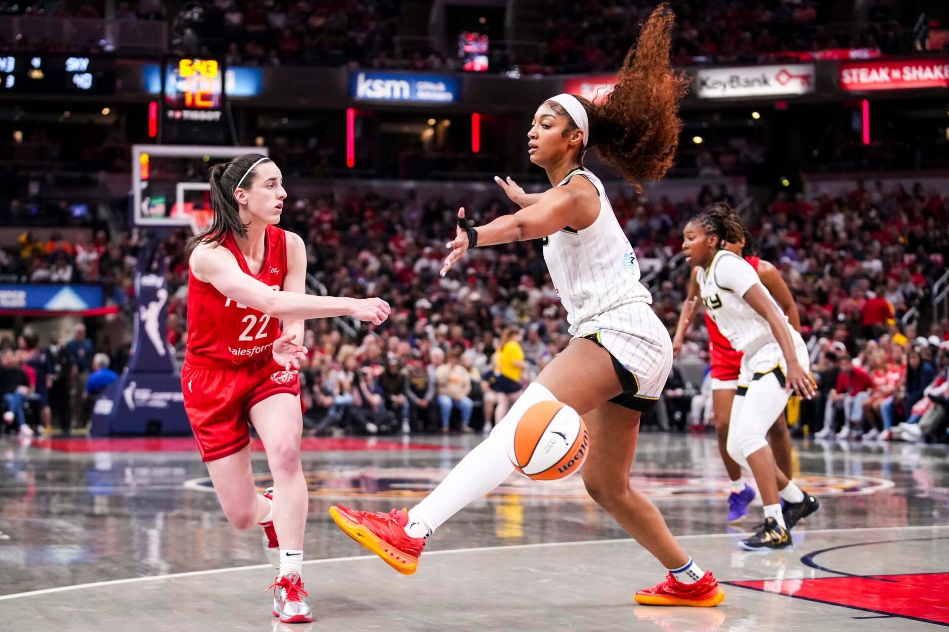 Indiana Fever guard Caitlin Clark (22) passes around Chicago Sky forward Angel Reese (5) on Saturday, May 17, 2025, during a game between the Indiana Fever and the Chicago Sky at Gainbridge Fieldhouse in Indianapolis. The Indiana Fever defeated the Chicago Sky, 93-58.