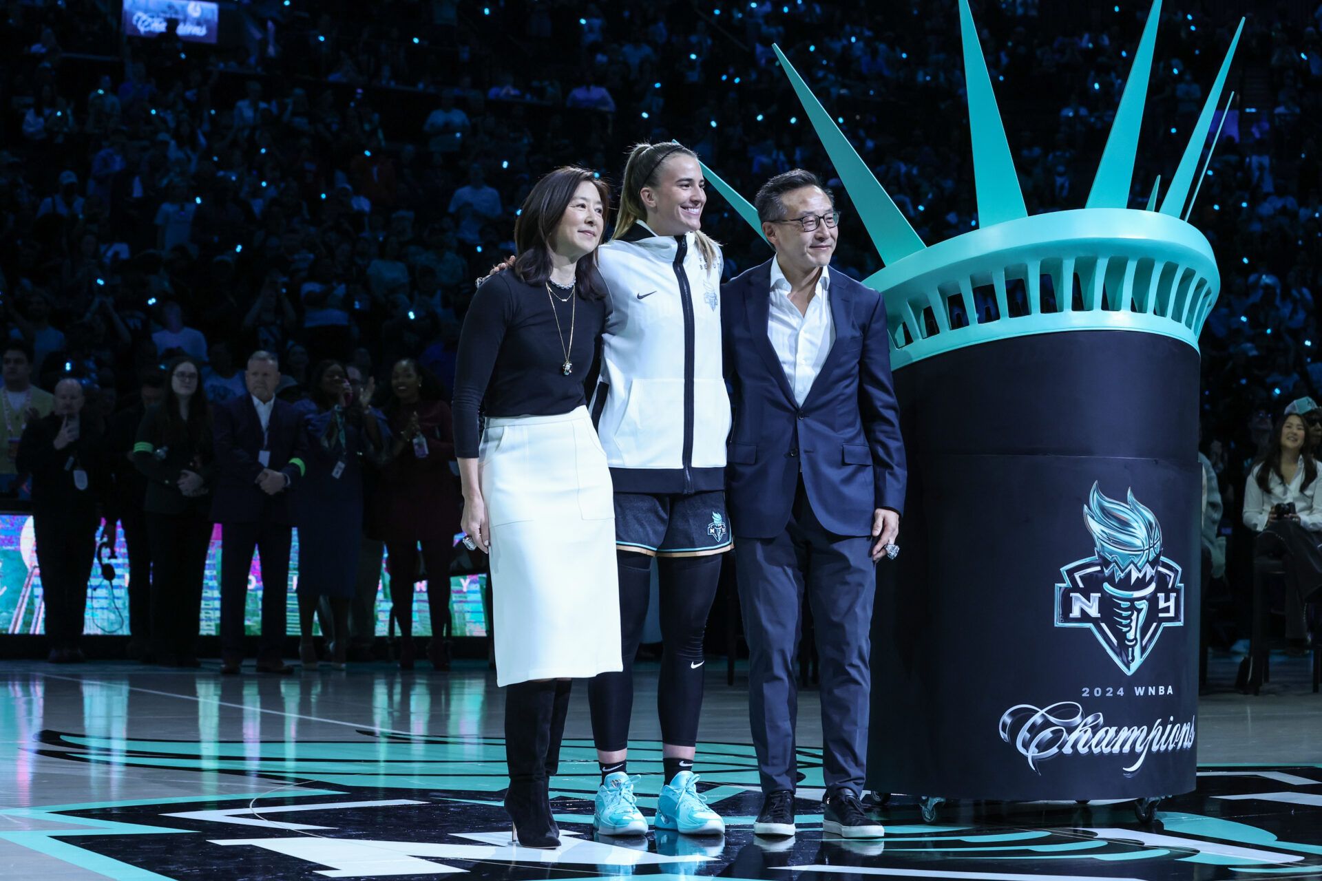 New York Liberty guard Sabrina Ionescu (20) stands with team owners Clara Wu Tsai and Joseph Tsai during the pregame ceremonies at Barclays Center.