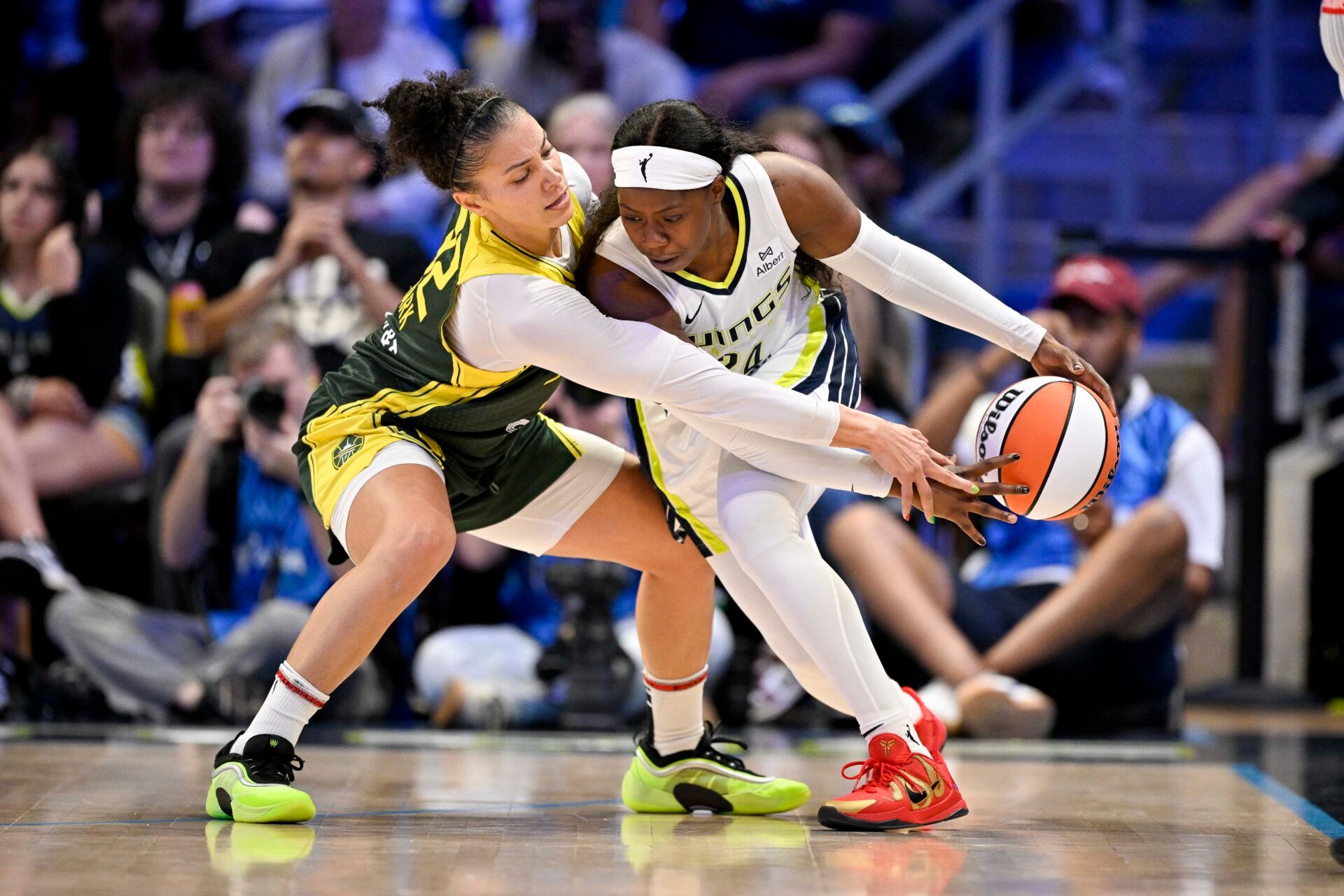 Seattle Storm forward Alysha Clark (32) tries to knock the ball away from Dallas Wings guard Arike Ogunbowale (24) during the second half at College Park Center.