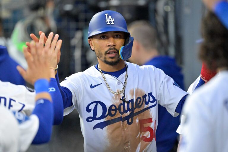 Los Angeles Dodgers shortstop Mookie Betts (50) celebrates after he scored a run against the Athletics during the first inning of the game at Dodger Stadium.