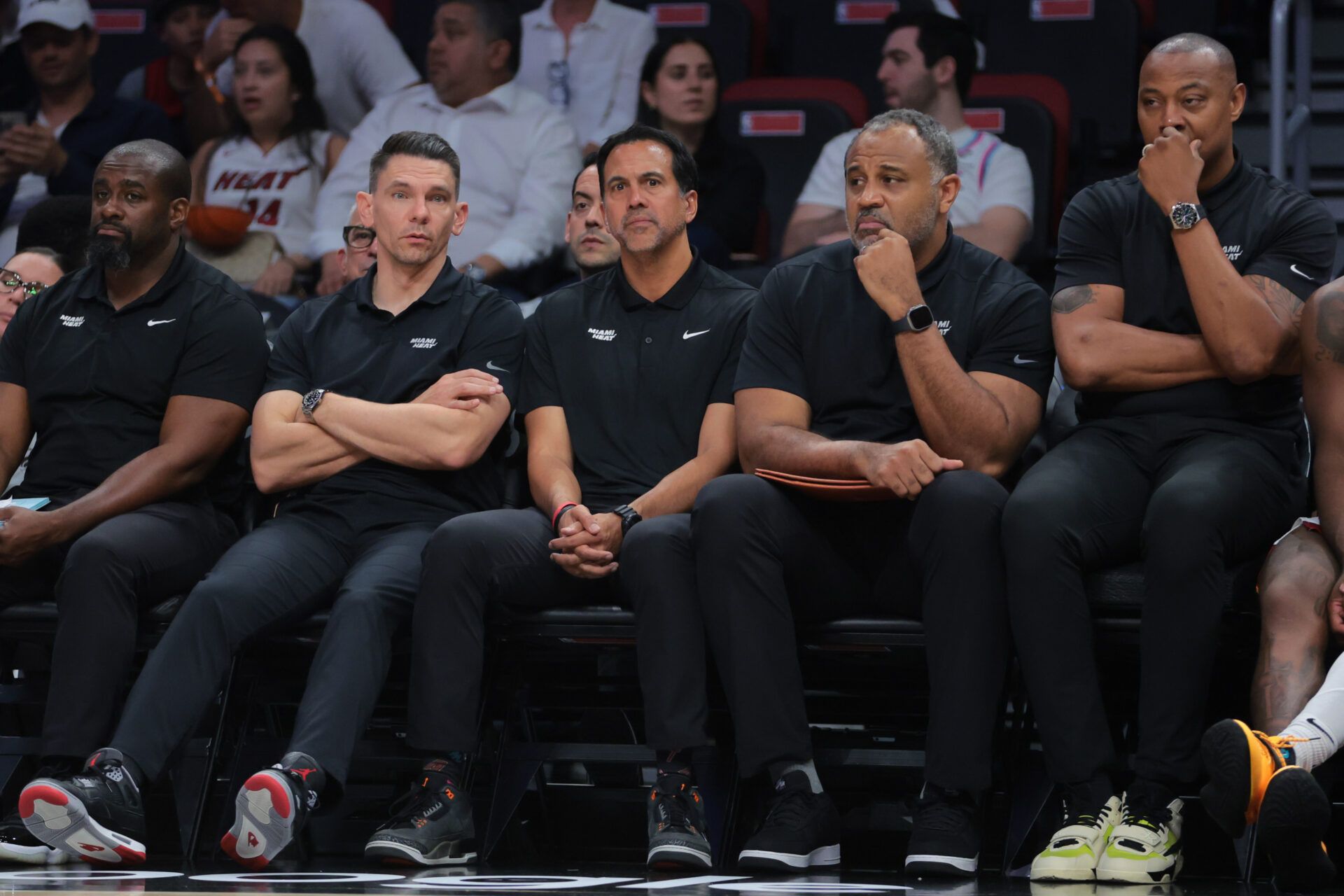 Miami Heat associate head coach Chris Quinn (left), head coach Erik Spoelstra (center), assistant coach Malik Allen and assistant coach Caron Butler (right) look on from the bench against the Cleveland Cavaliers in the fourth quarter during game four for the first round of the 2025 NBA Playoffs at Kaseya Center.
