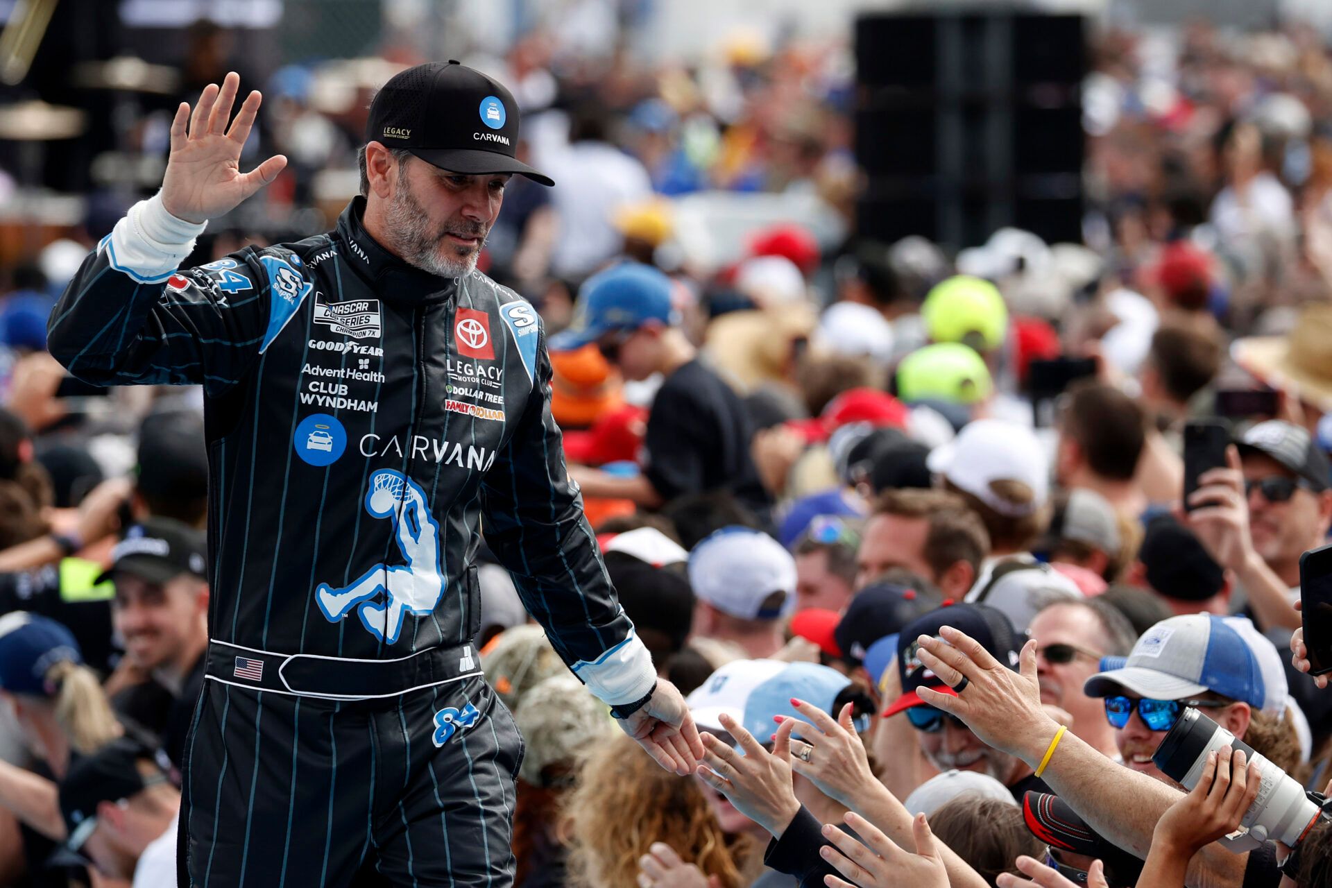 NASCAR Cup Series driver Jimmie Johnson (84) walks onto the driver introduction stage to greet fans before the Daytona 500 at Daytona International Speedway.