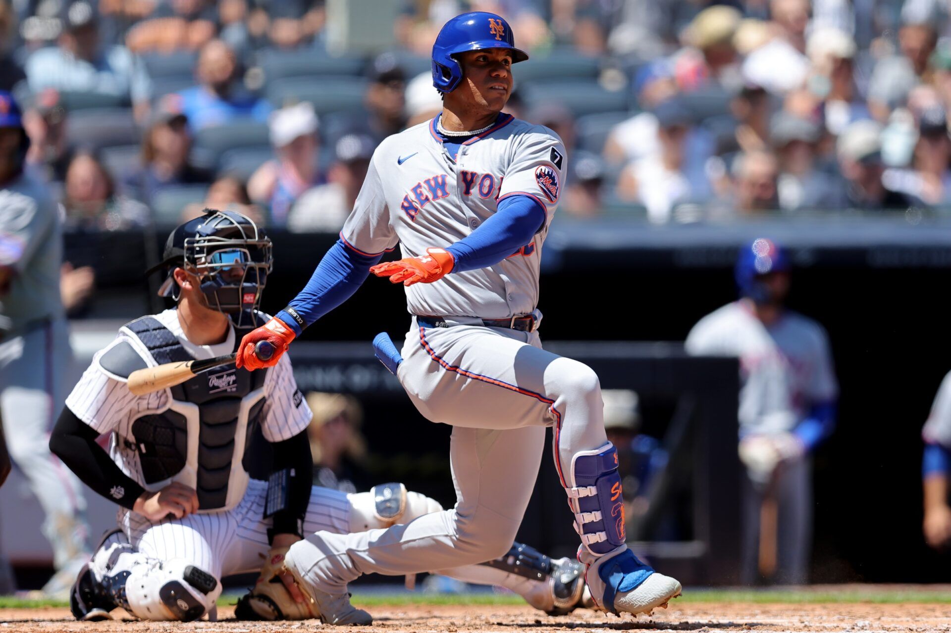 New York Mets right fielder Juan Soto (22) follows through on a single against the New York Yankees during the fourth inning at Yankee Stadium.
