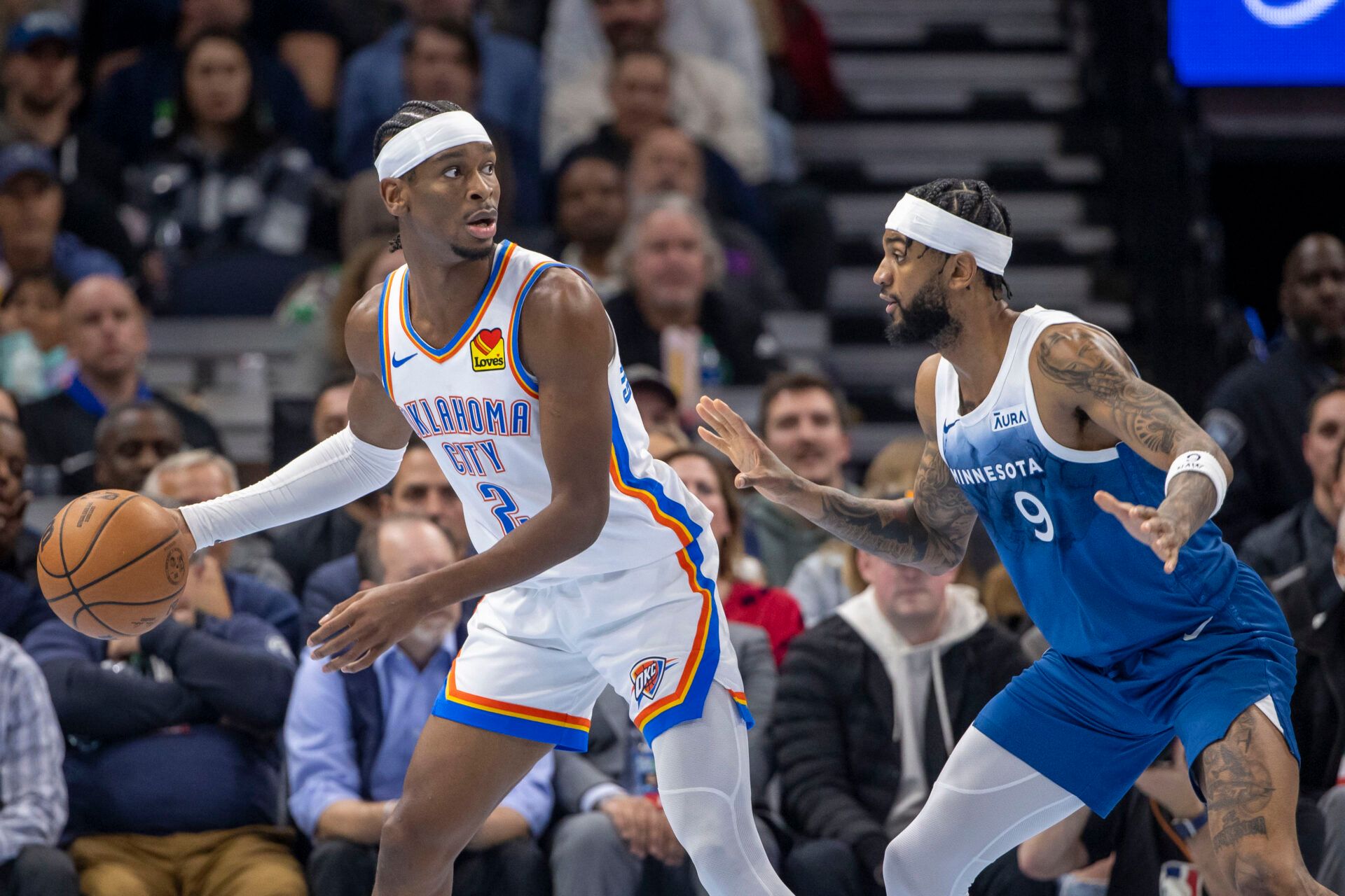 Oklahoma City Thunder guard Shai Gilgeous-Alexander (2) looks to pass around Minnesota Timberwolves guard Nickeil Alexander-Walker (9) in the second half at Target Center.
