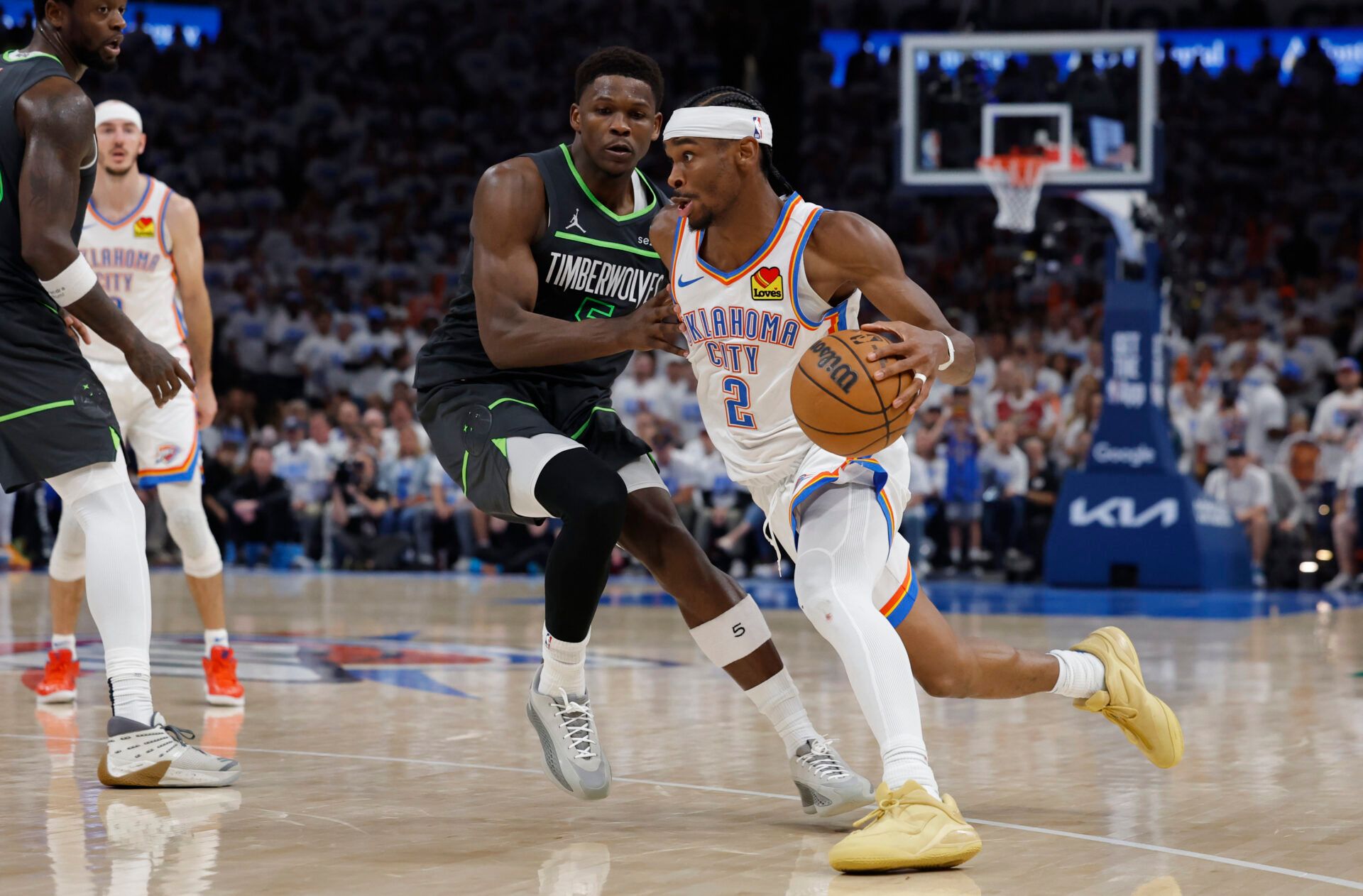 Oklahoma City Thunder guard Shai Gilgeous-Alexander (2) drives against Minnesota Timberwolves guard Anthony Edwards (5) in the fourth quarter during game one of the western conference finals for the 2025 NBA Playoffs at Paycom Center.