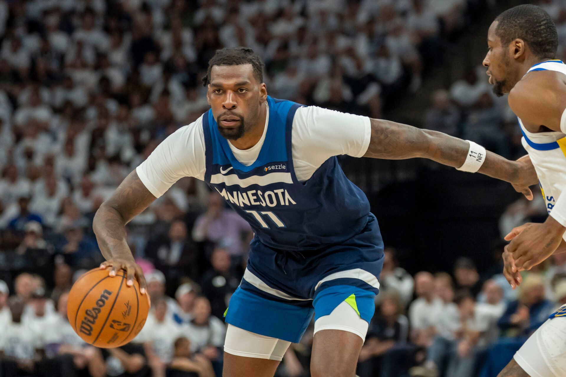 Minnesota Timberwolves center Naz Reid (11) dribbles the ball against the Golden State Warriors in the first half during game five of the second round for the 2025 NBA Playoffs at Target Center.