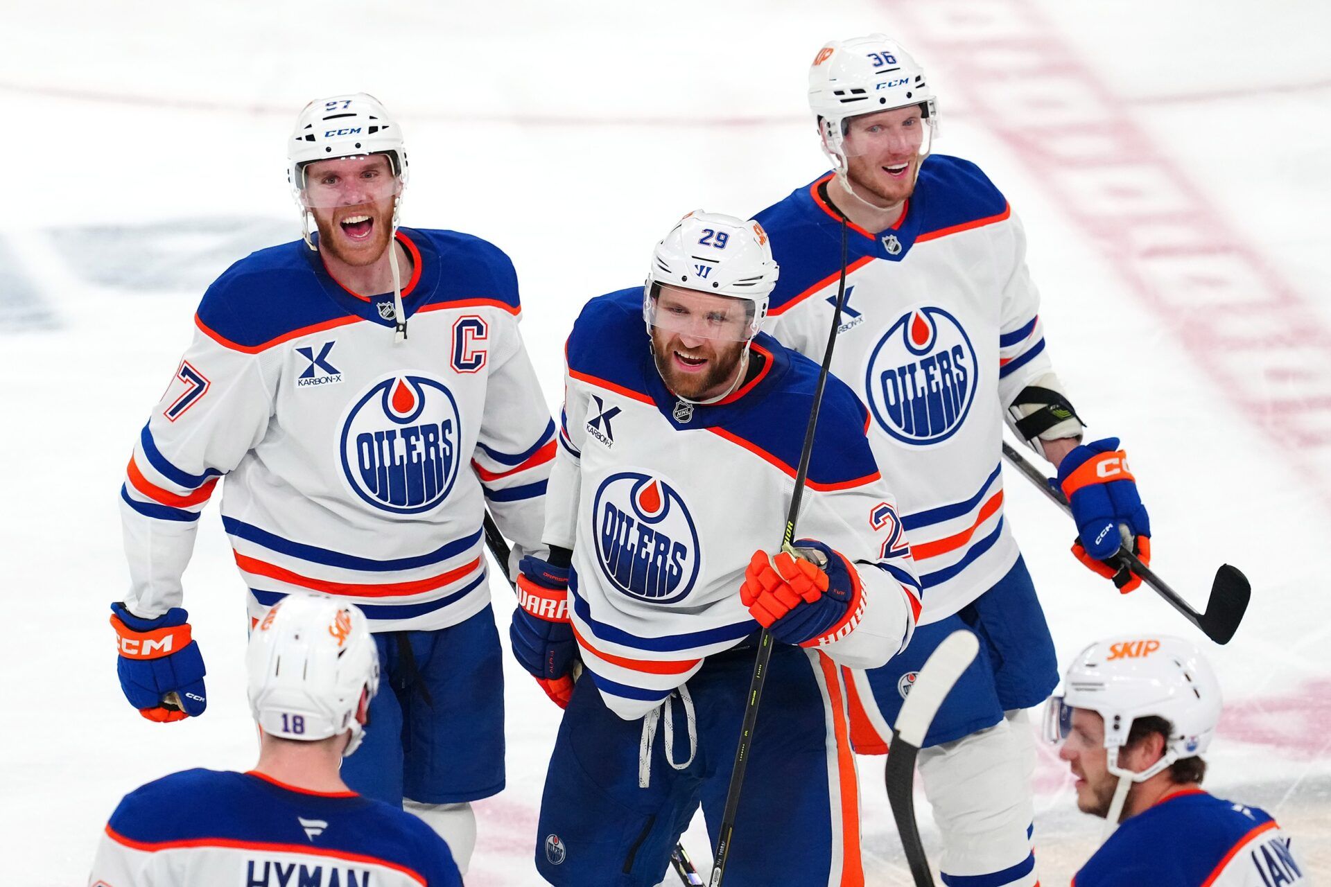 Edmonton Oilers center Connor McDavid (97) celebrates with center Leon Draisaitl (29) and goaltender Olivier Rodrigue (35) after the Oilers defeated the Vegas Golden Knights 1-0 during an overtime victory, completing a 4-1 series win during game five of the second round of the 2025 Stanley Cup Playoffs at T-Mobile Arena.