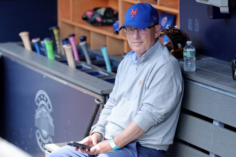 New York Mets owner Steve Cohen sits in the dugout after batting practice before a game against the New York Yankees at Yankee Stadium.