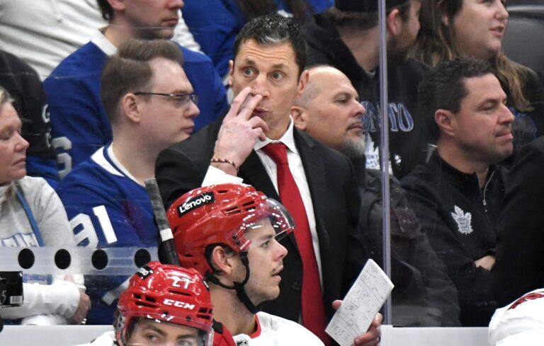 Carolina Hurricanes head coach Rod Brind'Amour gestures to goalie Pyotr Kochetkov (not shown) to watch for a signal to leave his net for an extra attacker in the third period against the Toronto Maple Leafs at Scotiabank Arena.