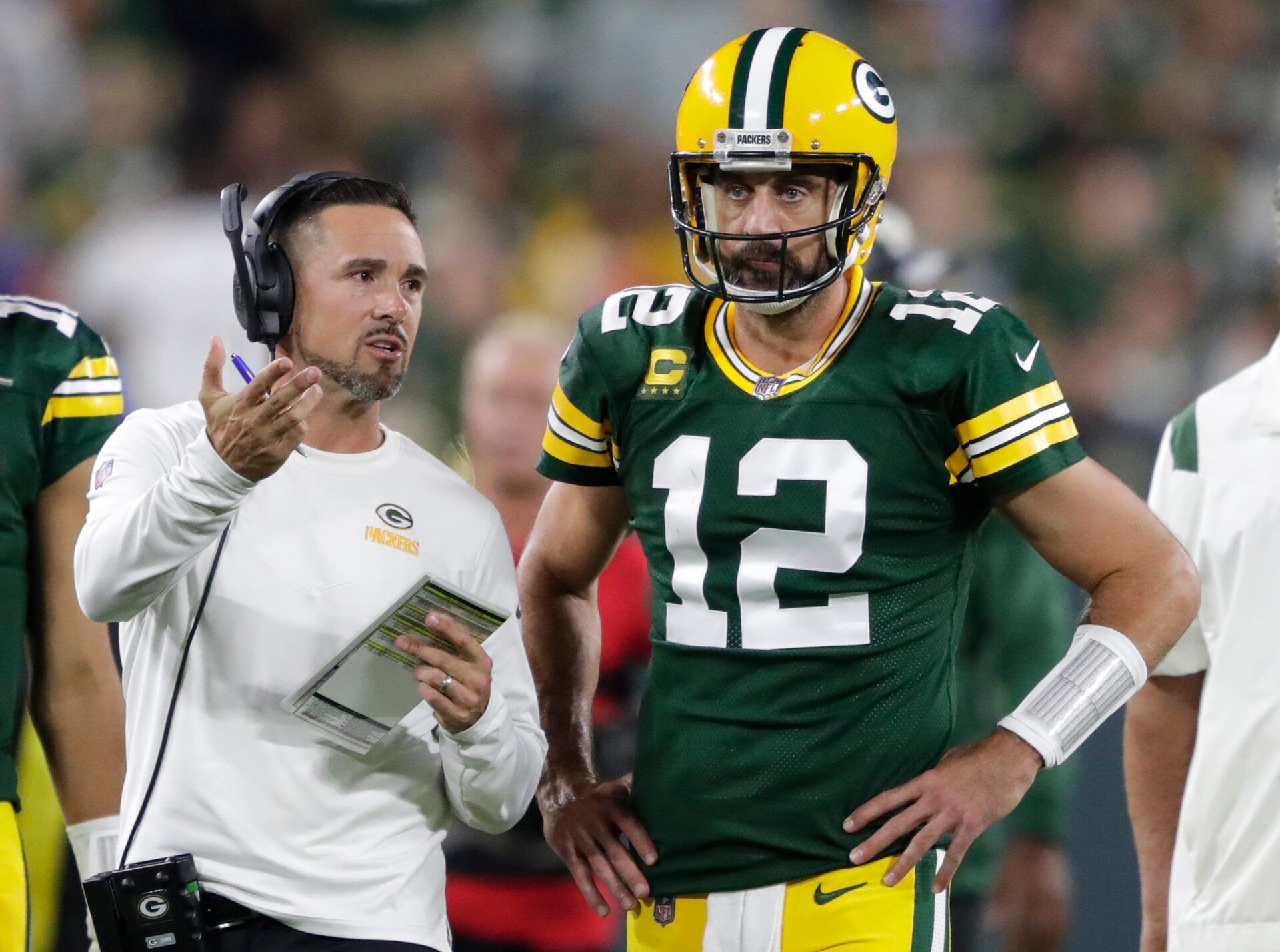 Green Bay Packers head coach Matt LaFleur talks with quarterback Aaron Rodgers (12) in between quarters against the Chicago Bears during their game on Sep 18, 2022, in Green Bay, Wisconsin.