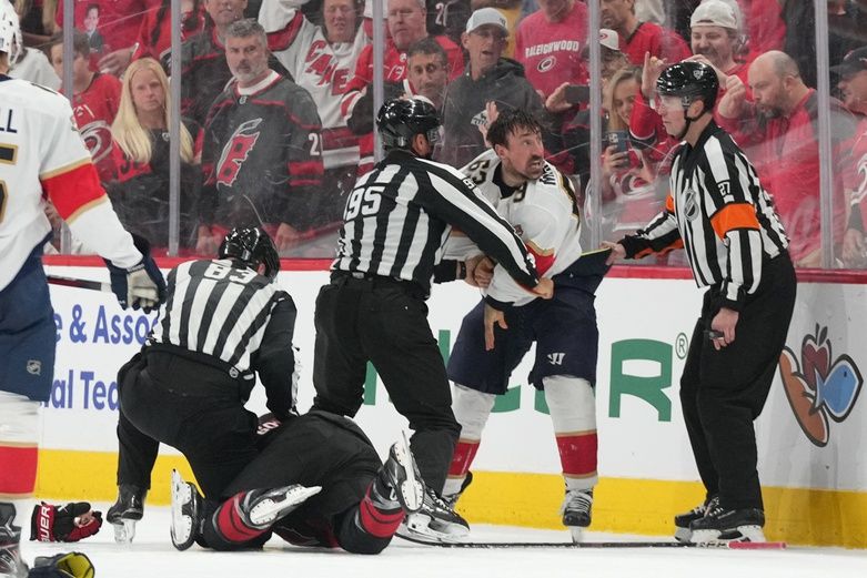 Florida Panthers forward Brad Marchand (63) fights Carolina Hurricanes defenseman Shayne Gostibehere (4) during the third period in game one of the Eastern Conference Final of the 2025 Stanley Cup Playoffs at Lenovo Center.