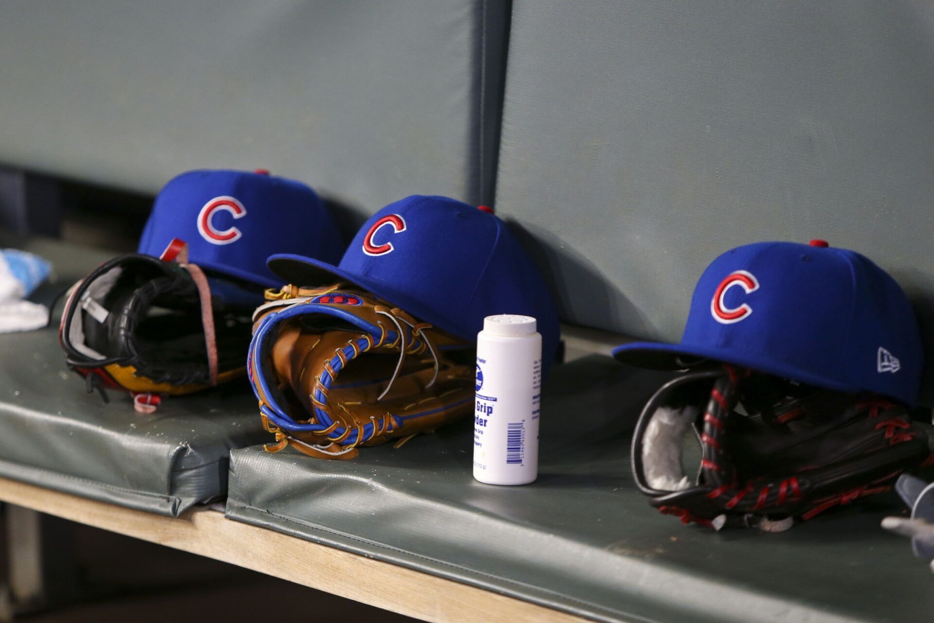 Detailed view of Chicago Cubs hats and gloves in the dugout against the Atlanta Braves in the fifth inning at SunTrust Park.