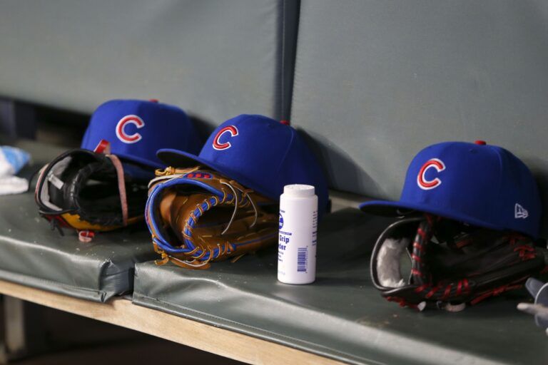Detailed view of Chicago Cubs hats and gloves in the dugout against the Atlanta Braves in the fifth inning at SunTrust Park.