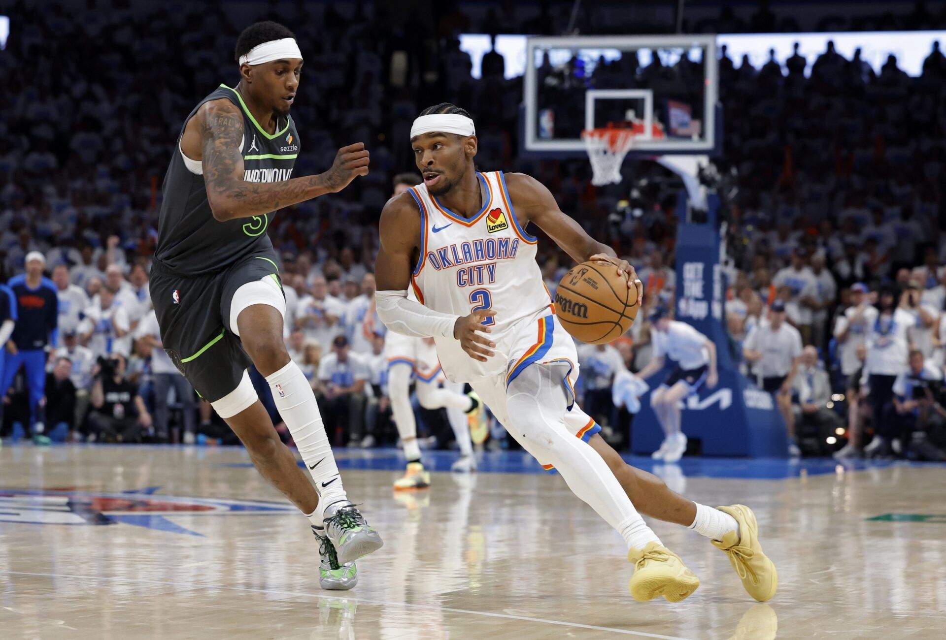 Oklahoma City Thunder guard Shai Gilgeous-Alexander (2) drives against Minnesota Timberwolves forward Jaden McDaniels (3) in the fourth quarter during game one of the western conference finals for the 2025 NBA Playoffs at Paycom Center.