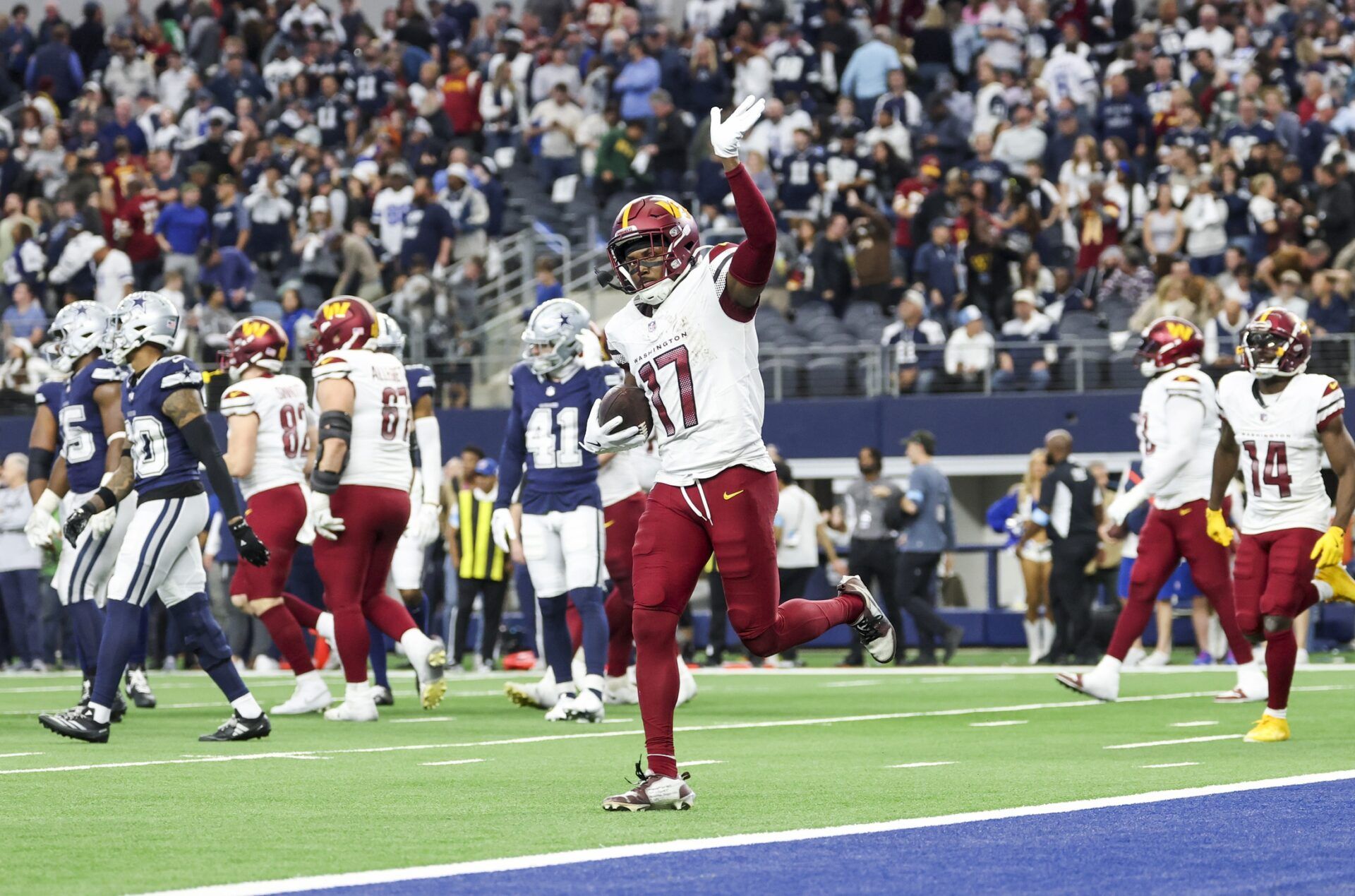 Washington Commanders wide receiver Terry McLaurin (17) celebrates after scoring the game-winning touchdown  during the fourth quarter against the Dallas Cowboys at AT&T Stadium.