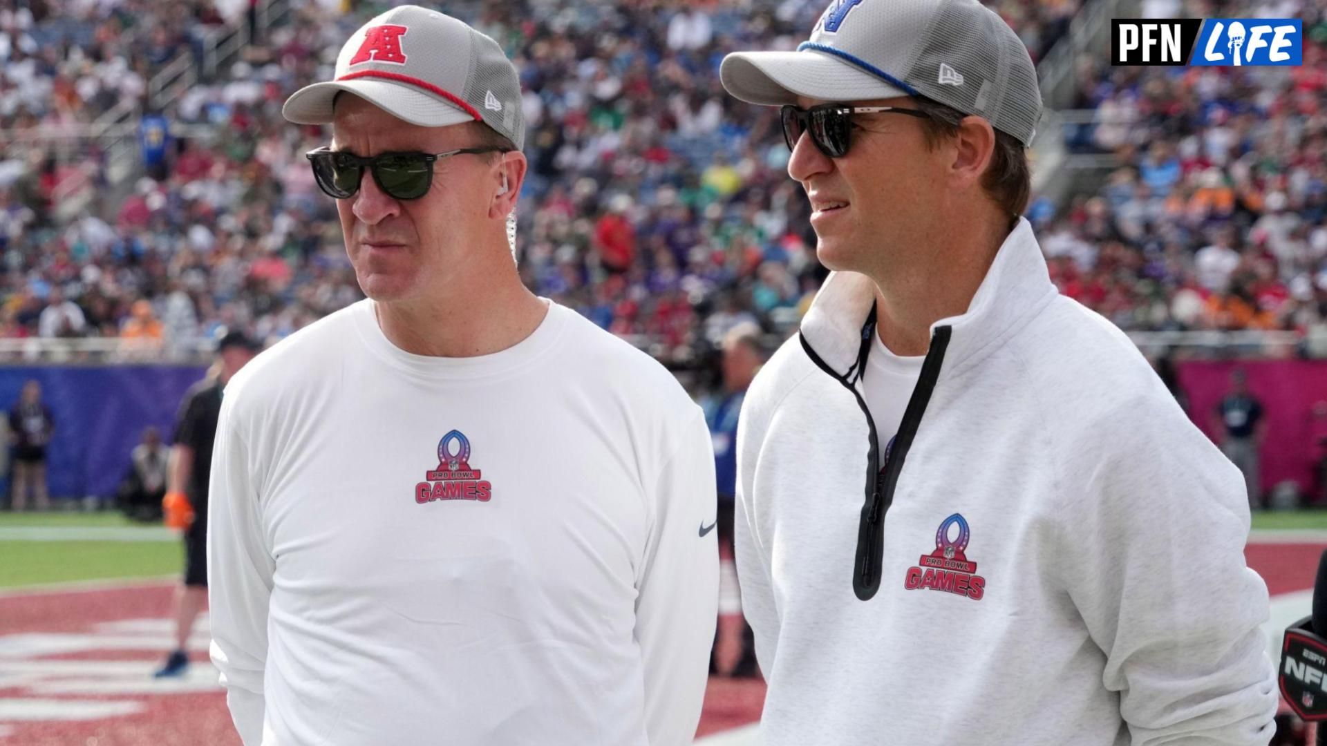 AFC coach Peyton Manning (left) and brother and NFC coach Eli Manning watch during the 2025 Pro Bowl Games at Camping World Stadium.