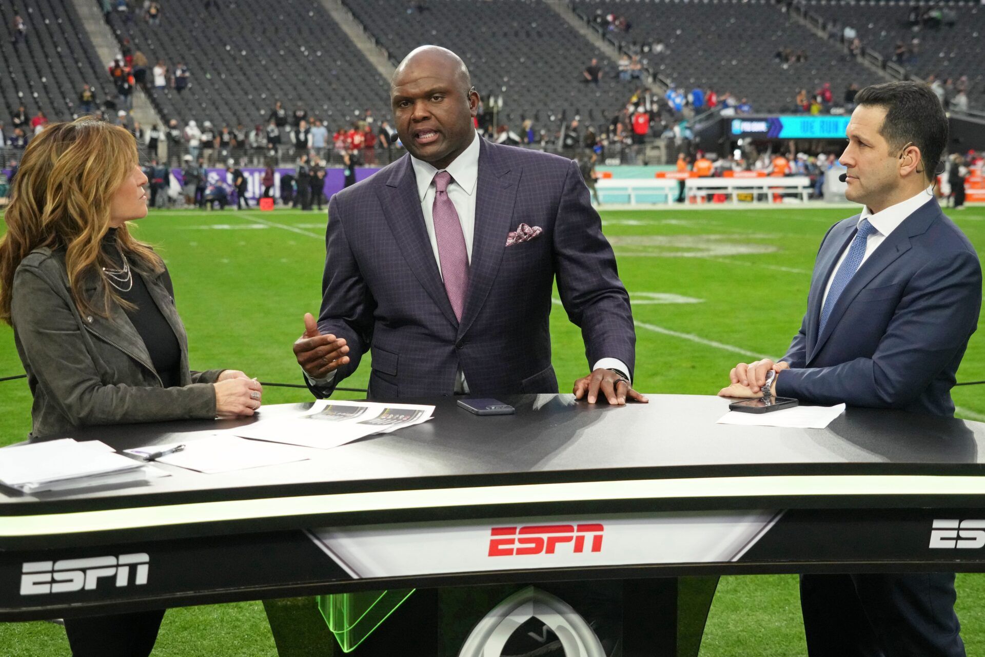 ESPN personalities Suzy Kolber (left) and Booger McFarland (center) and Adam Schefter (right) talk after the Pro Bowl football game at Allegiant Stadium. The AFC won 41-35.