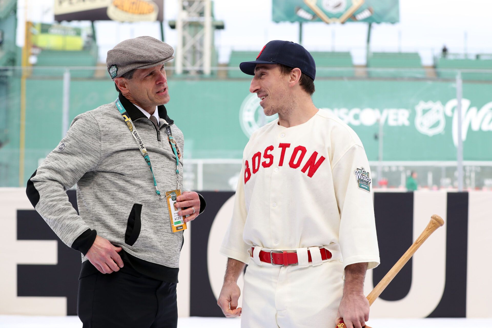 Boston Bruins left wing Brad Marchand (63) talks with general manager Don Sweeney before a game against the Pittsburgh Penguins in the 2023 Winter Classic ice hockey game at Fenway Park.