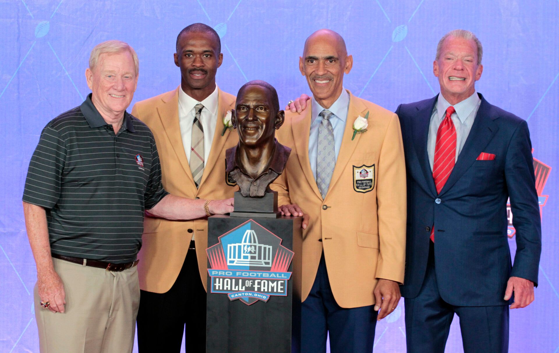 Former NFL contributor Bill Poulin (L) and Indianapolis Colts receiver Marvin Harrison (LC) and former Colts head coach Tony Dungy (RC) and Colts owner Jim Irsay pose during the 2016 NFL Hall of Fame enshrinement at Tom Benson Hall of Fame Stadium.