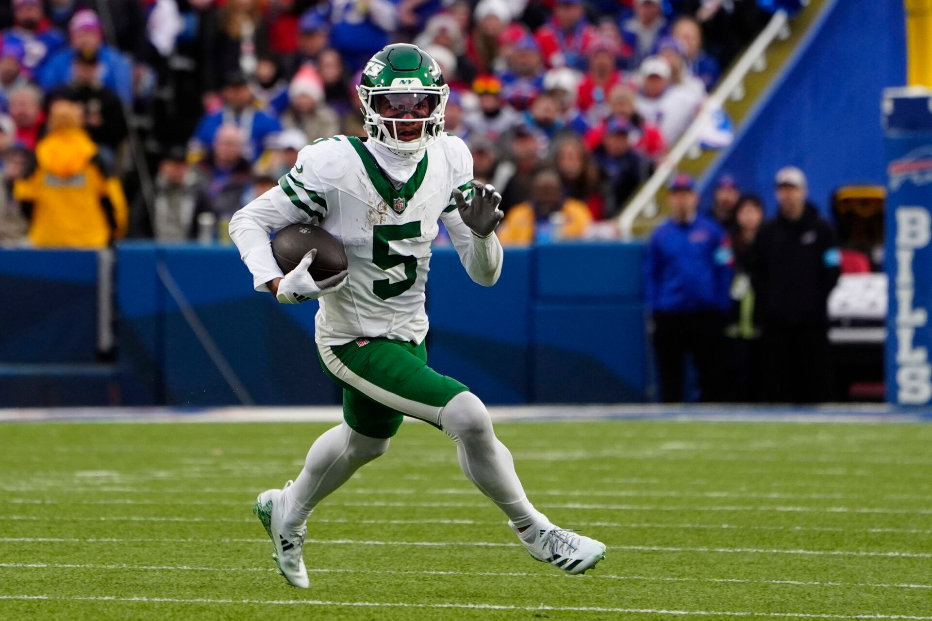 New York Jets wide receiver Garrett Wilson (5) runs with the ball after making a catch against the Buffalo Bills during the second half at Highmark Stadium.