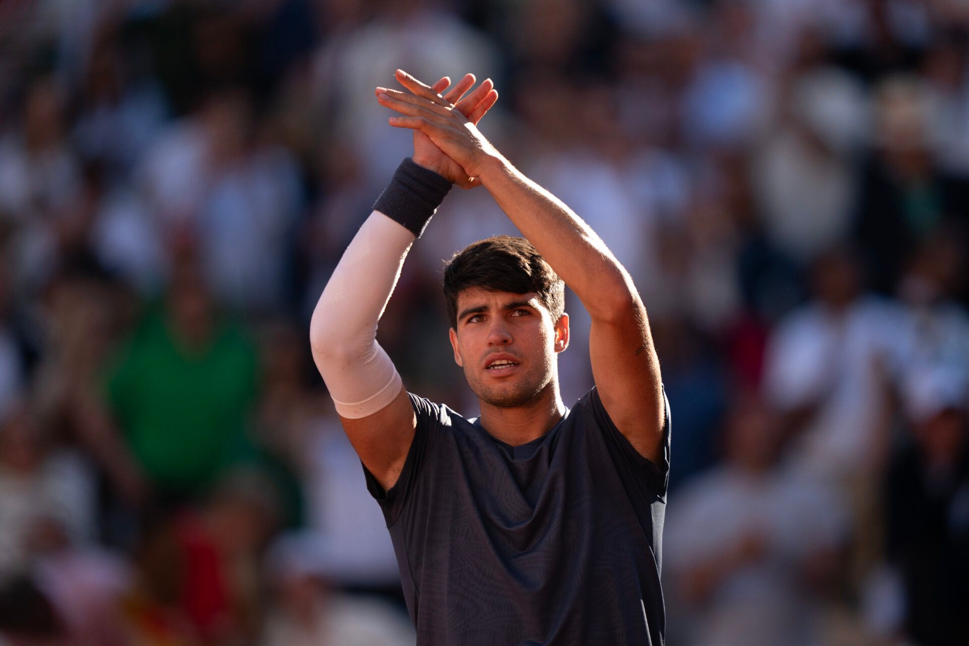 Carlos Alcaraz of Spain celebrates winning his match against Jannik Sinner of Italy on  day 13 of Roland Garros at Stade Roland Garros.