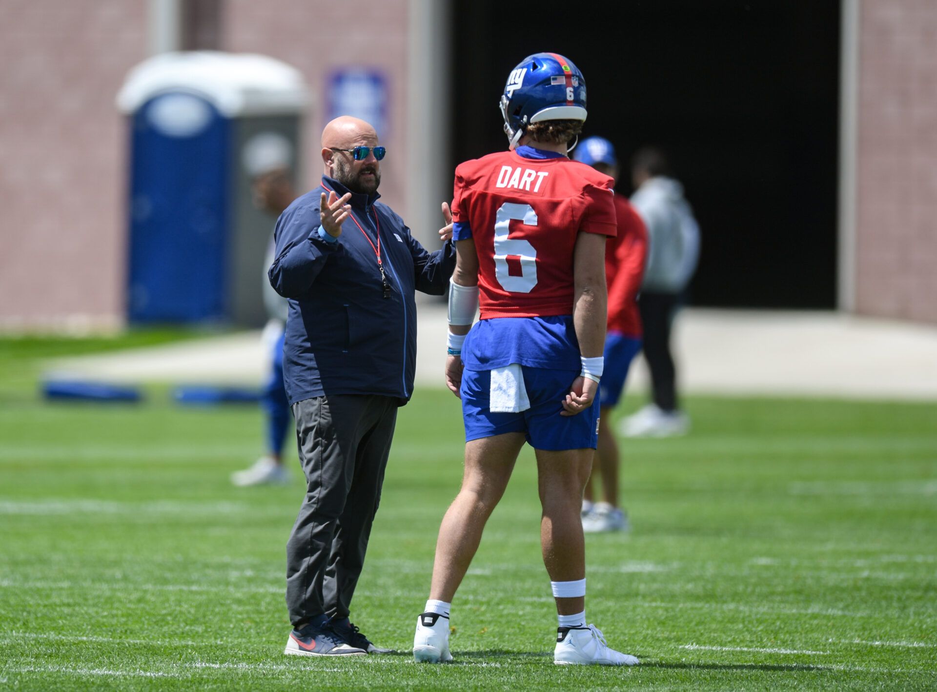 New York Giants head coach Brian Daboll talks to quarterback Jaxson Dart (6) during rookie minicamp at Quest Diagnostics Training Center.