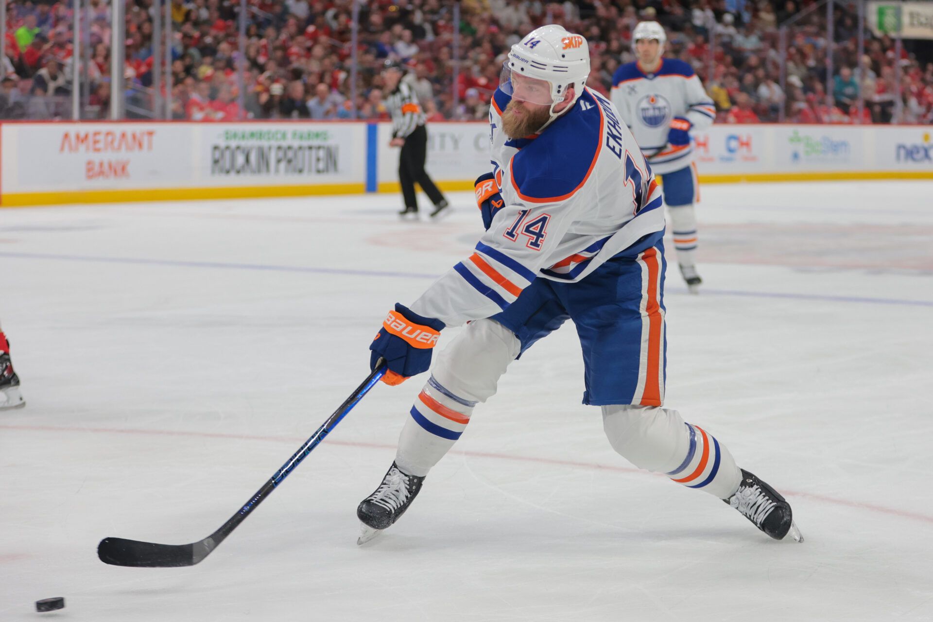 Edmonton Oilers defenseman Mattias Ekholm (14) shoots the puck against the Florida Panthers during the first period at Amerant Bank Arena.