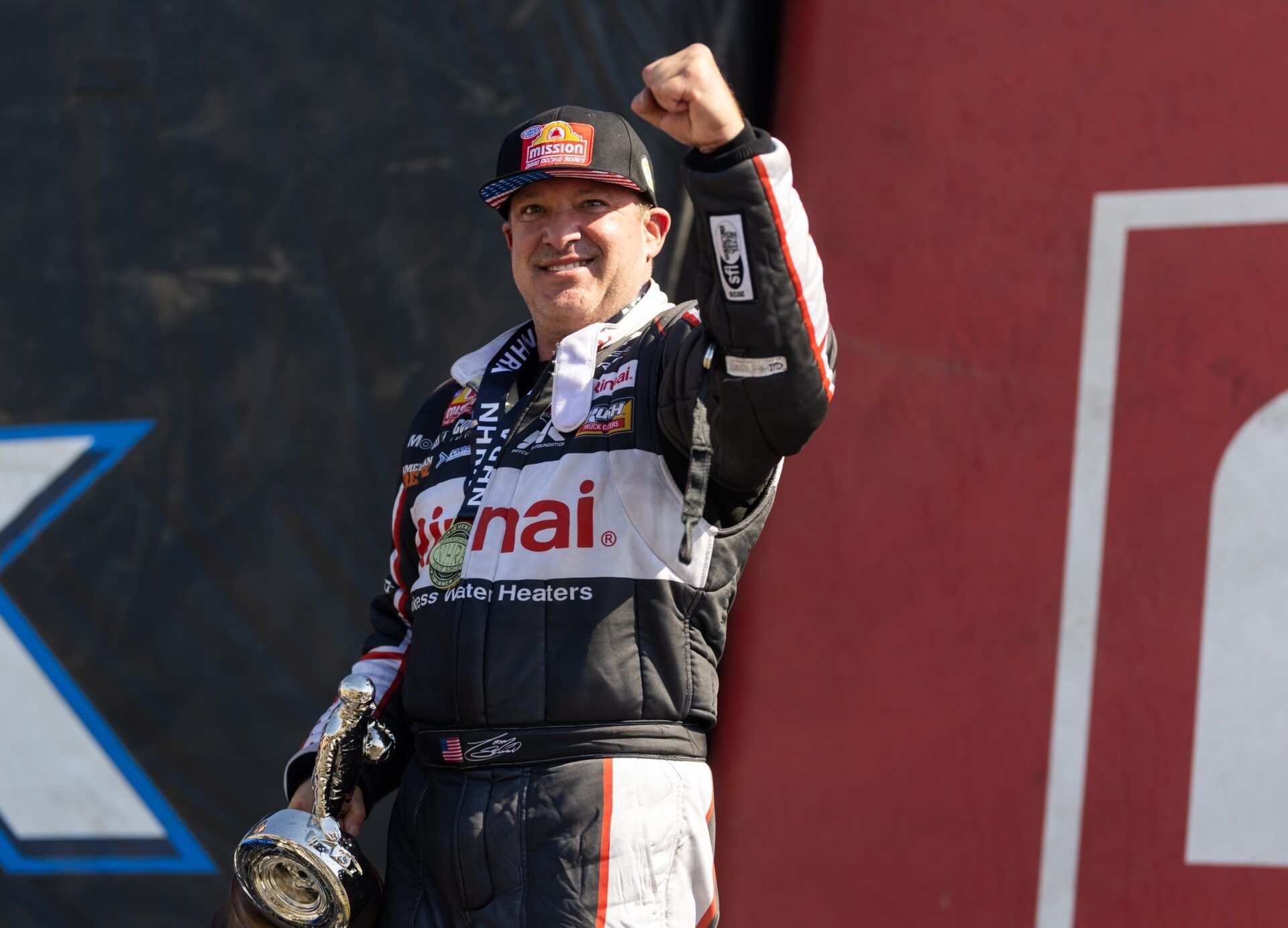 NHRA top fuel driver Tony Stewart celebrates after winning the Route 66 Nationals at Route 66 Raceway.