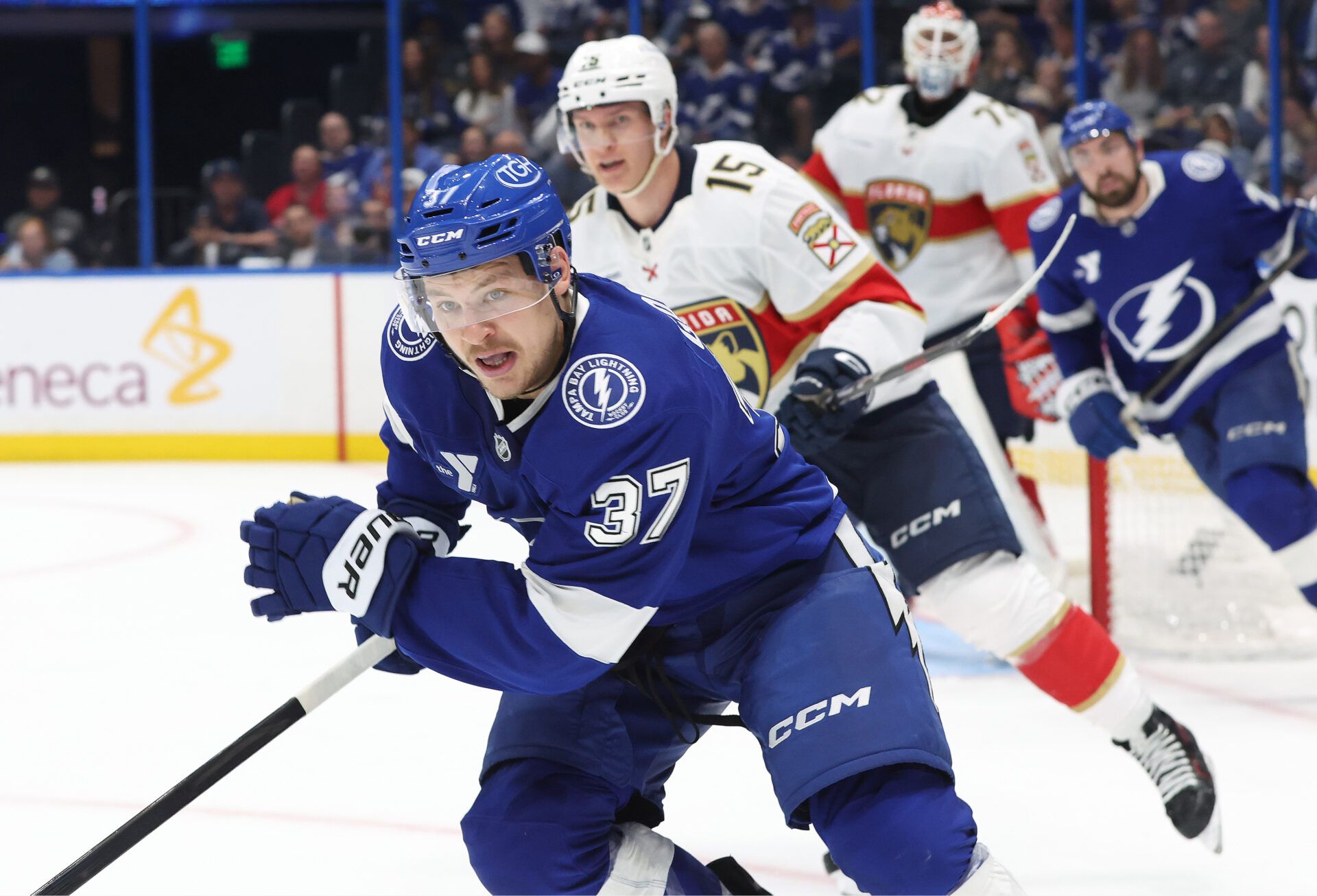 Tampa Bay Lightning center Yanni Gourde (37) and Florida Panthers center Anton Lundell (15) skate during the  third period in game one of the first round of the 2025 Stanley Cup Playoffs at Amalie Arena.