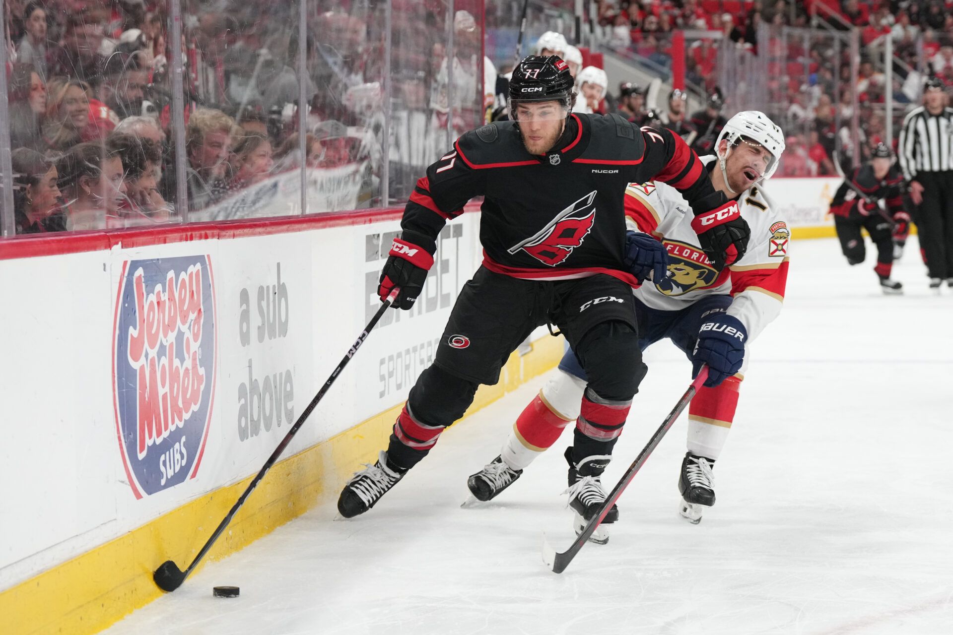 Carolina Hurricanes forward Mark Jankowski (77) controls the puck  against Florida Panthers forward Matthew Tkachuk (19) during the third period in game two of the Eastern Conference Final of the 2025 Stanley Cup Playoffs at Lenovo Center.