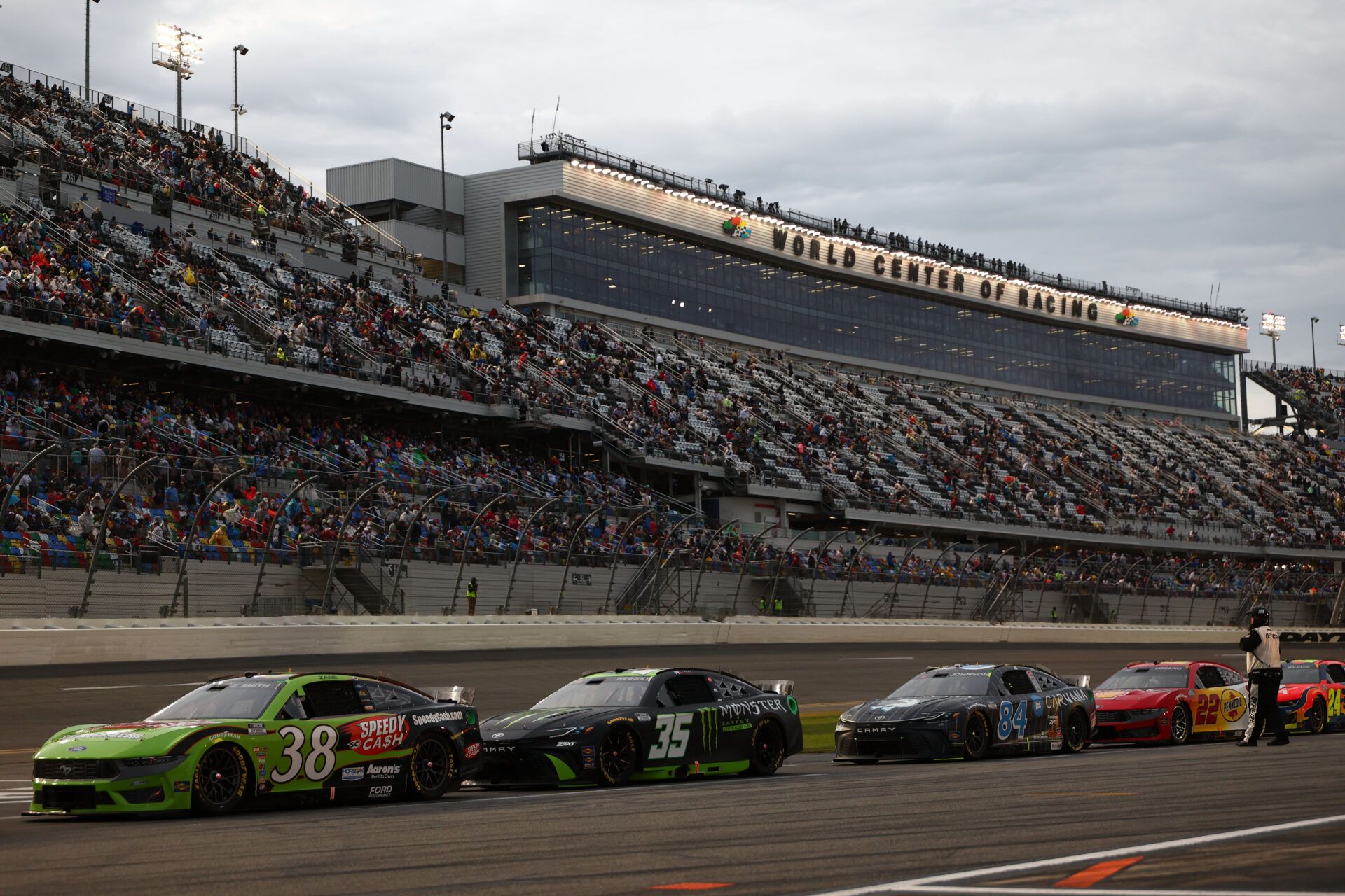 NASCAR Cup Series driver Zane Smith (38), driver Riley Herbst (35) and  driver Jimmie Johnson (84) leave pit row during the Daytona 500 at Daytona International Speedway.