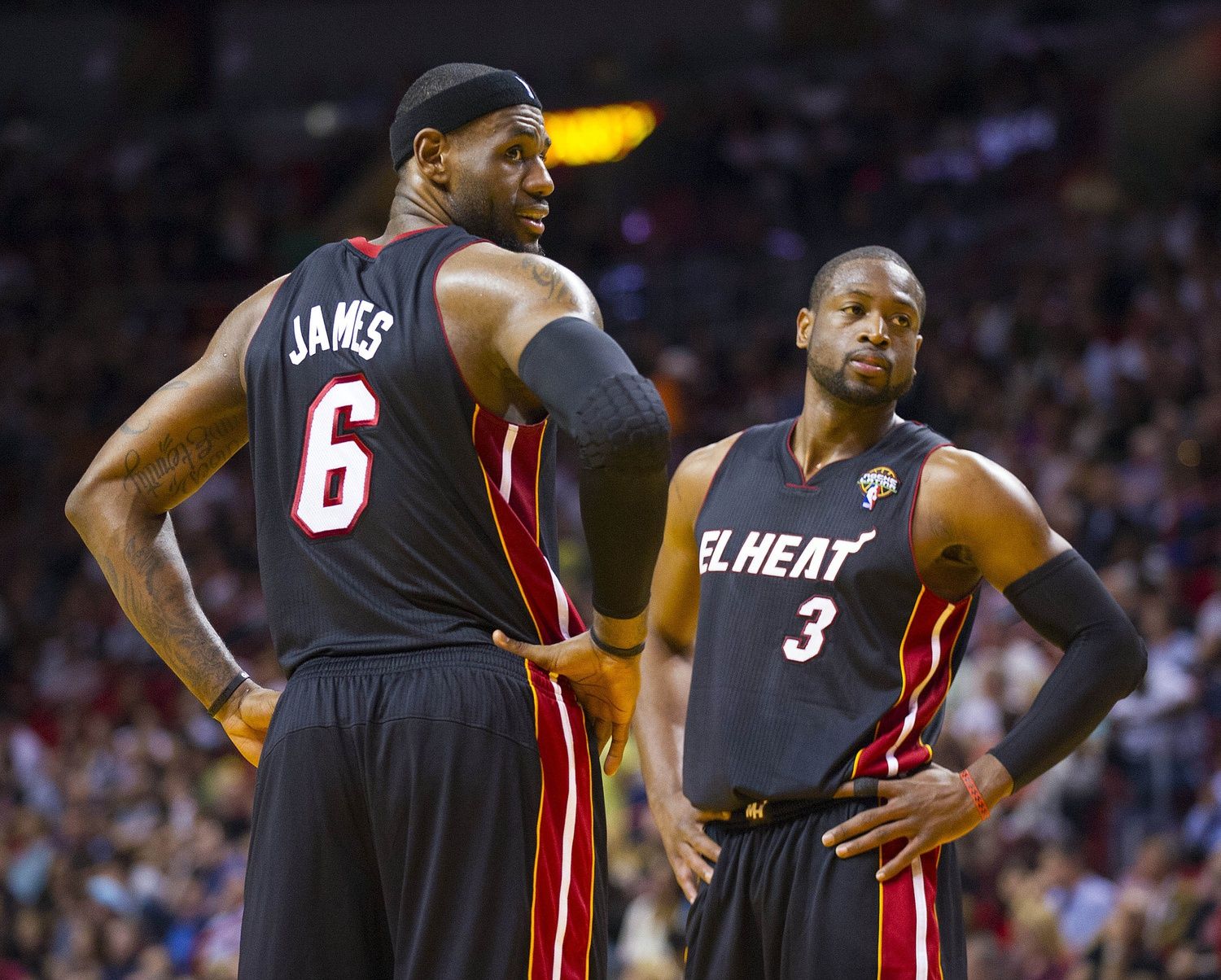 Miami Heat small forward LeBron James (6) and Heat shooting guard Dwyane Wade (3) react to some fans during the game against the Orlando Magic at the American Airlines Arena.