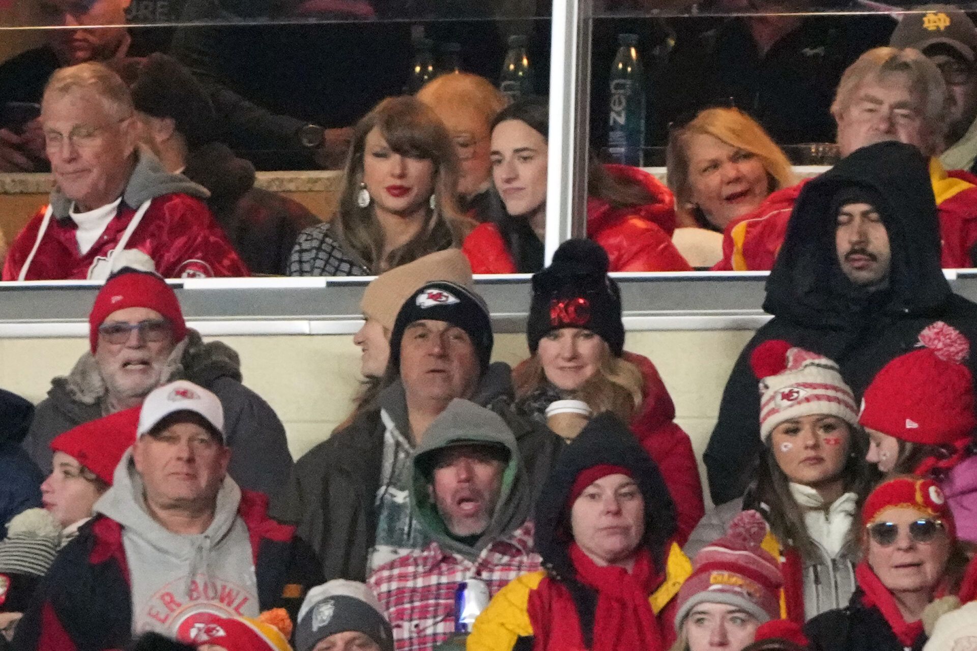 Recording artist Taylor Swift (upper middle) sits with Indiana Fever guard Caitlin Clark (upper right) during the fourth quarter of a 2025 AFC divisional round game between the Kansas City Chiefs and the Houston Texans at GEHA Field at Arrowhead Stadium.