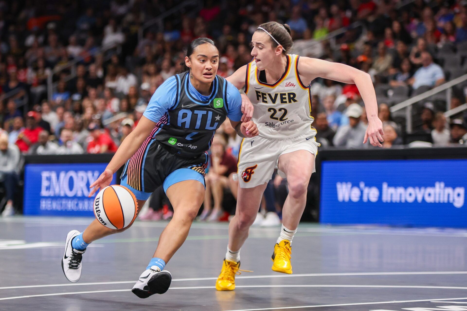 Atlanta Dream guard Te-Hina Paopao (2) drives on Indiana Fever guard Caitlin Clark (22) in the first half at State Farm Arena.