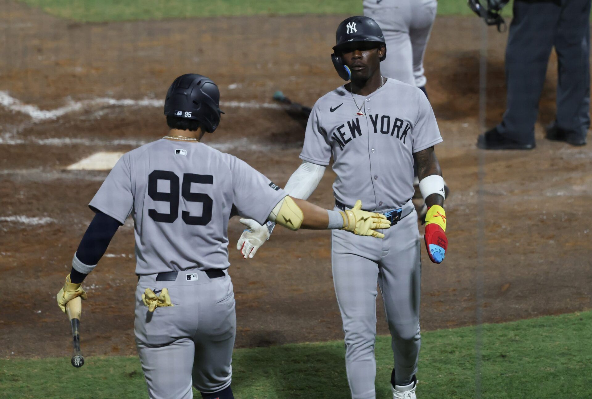New York Yankees second base Jazz Chisholm Jr. (13) is congratulated by third base Oswaldo Cabrera (95) after he scored T] during the sixth inning  at George M. Steinbrenner Field.