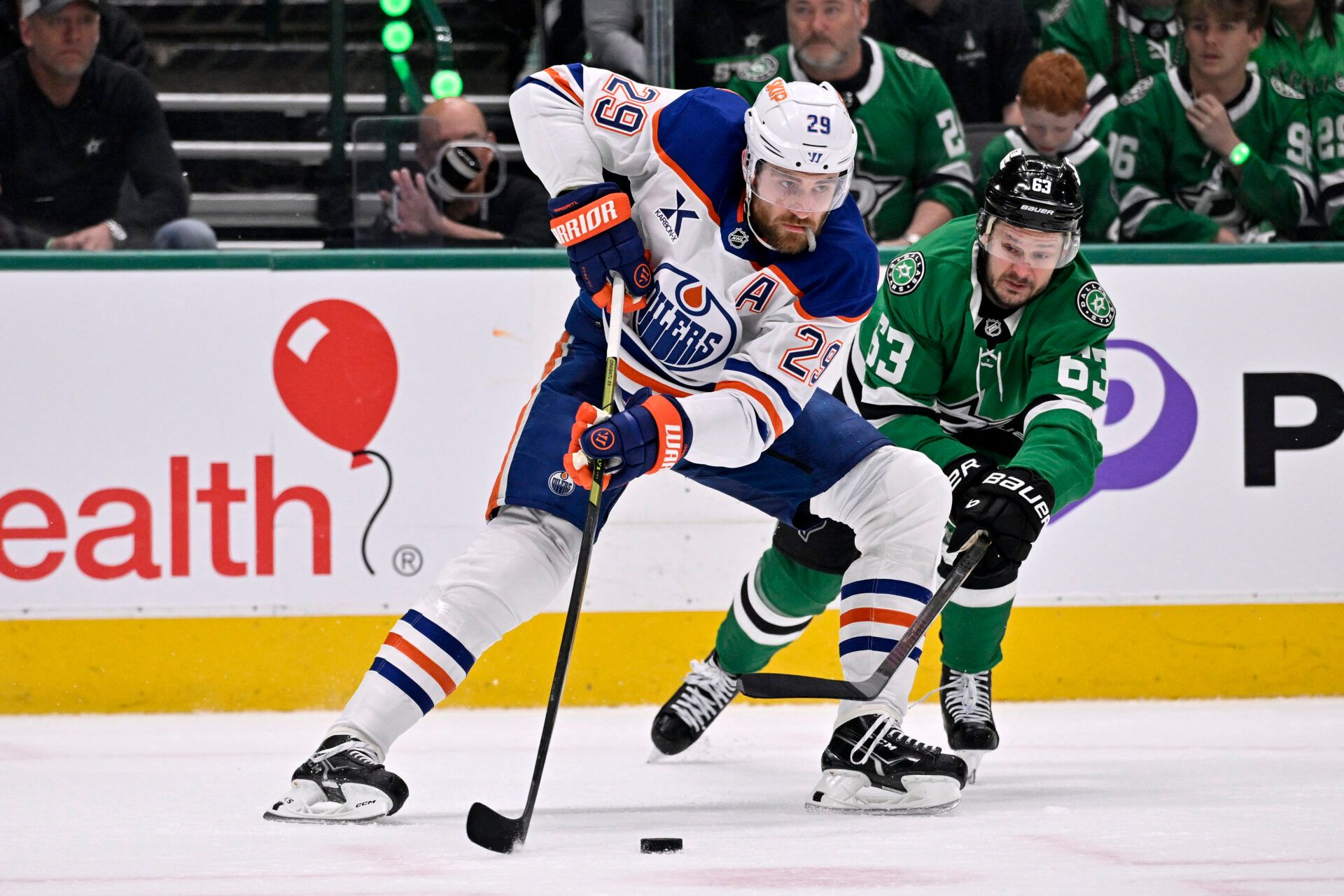 Edmonton Oilers center Leon Draisaitl (29) skates with the puck against Dallas Stars right wing Evgenii Dadonov (63) in the first period during game one of the Western Conference Final of the 2025 Stanley Cup Playoffs at American Airlines Center.