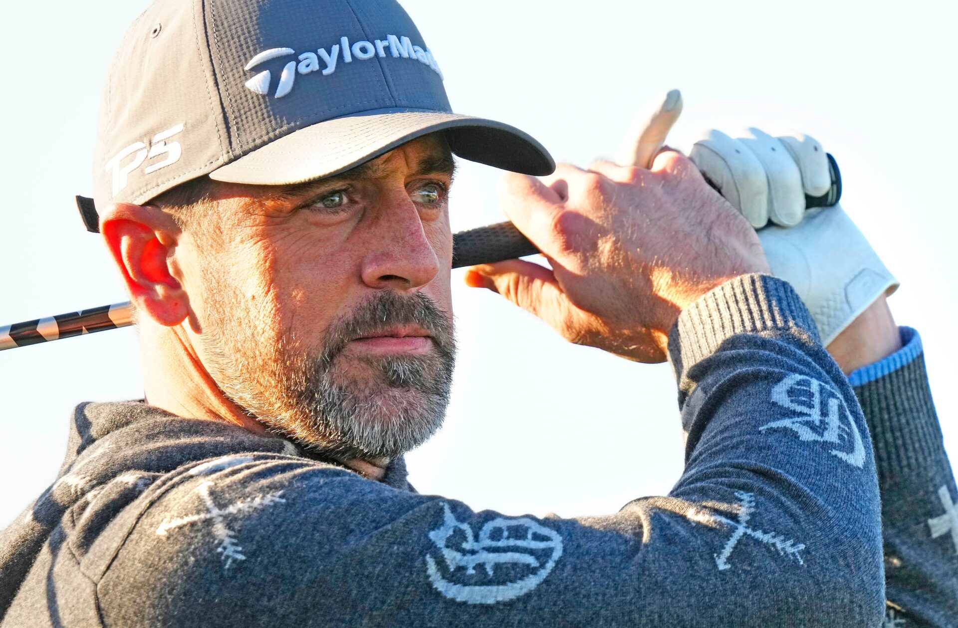 Jets quarterback Aaron Rodgers tees off on the first hole during the Phoenix Open Annexus Pro-Am at TPC Scottsdale on February 5, 2025.