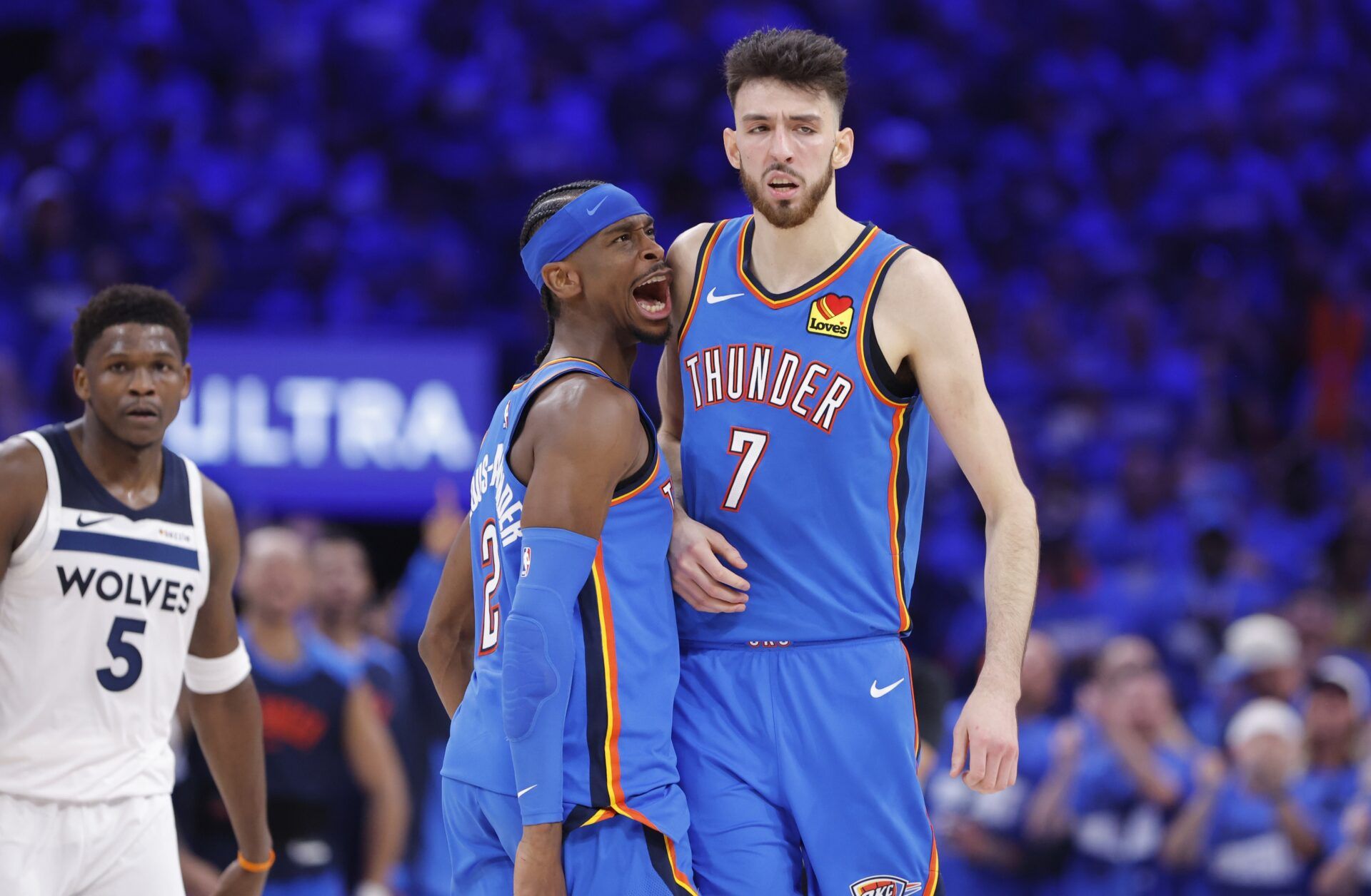 Oklahoma City Thunder guard Shai Gilgeous-Alexander (2) and forward Chet Holmgren (7) celebrate after a play against the Minnesota Timberwolves in the third quarter during game two of the western conference finals for the 2025 NBA Playoffs at Paycom Center.