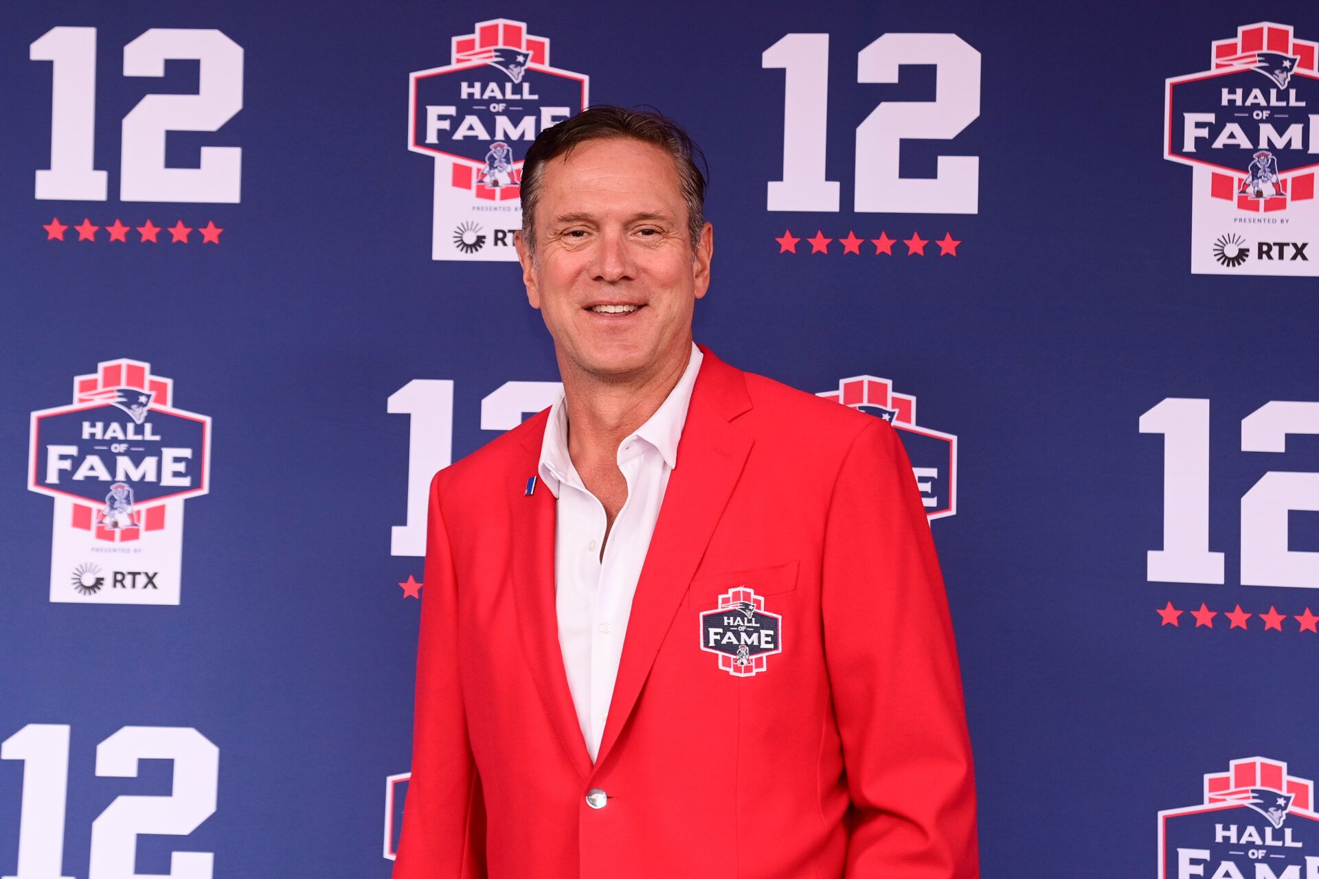 Former Patriots quarterback Drew Bledsoe stops on the red carpet for a photo during the New England Patriots Hall of Fame induction Ceremony for Tom Brady