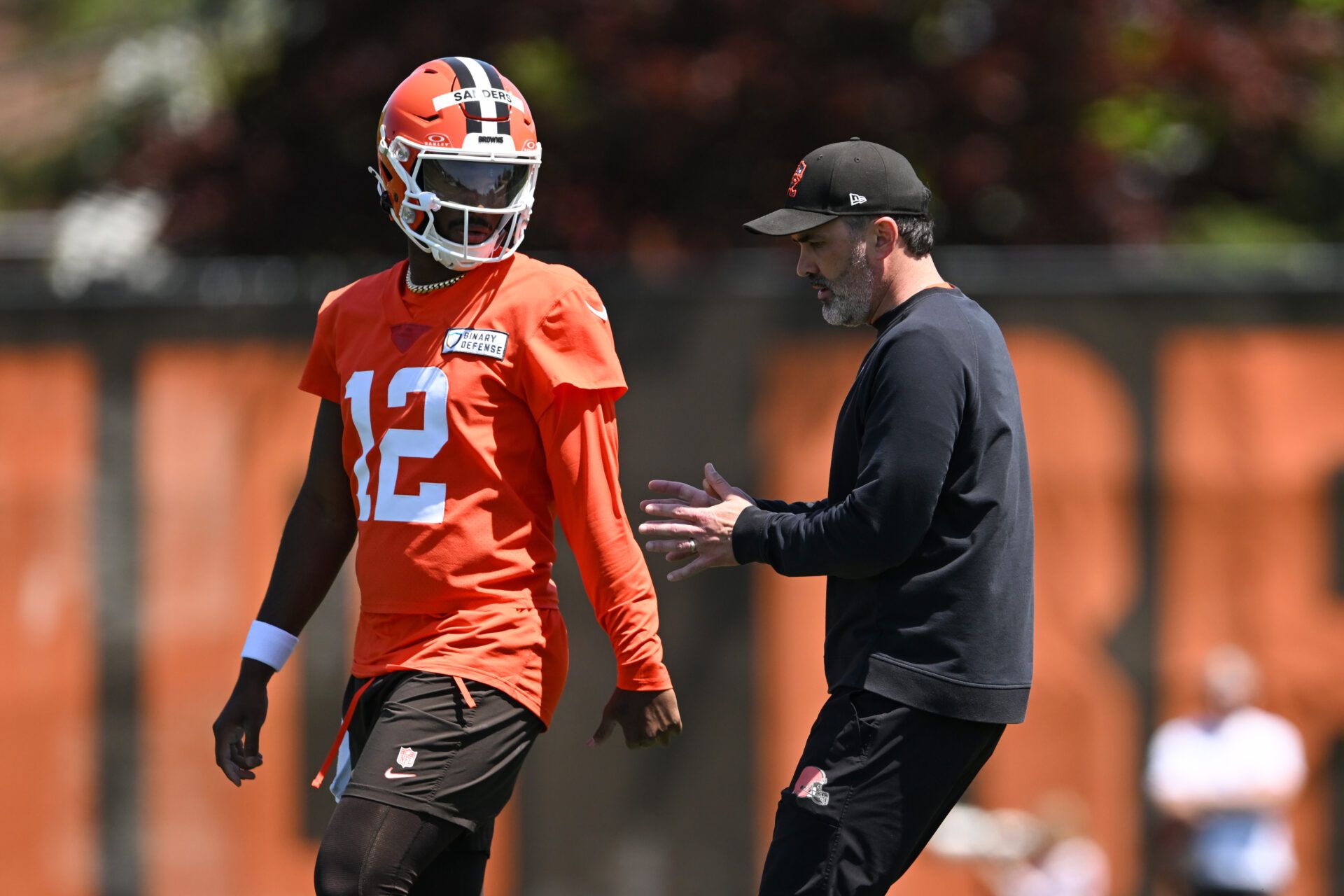 BEREA, OHIO - MAY 10: Head coach Kevin Stefanski of the Cleveland Browns instructs Shedeur Sanders #12 during rookie minicamp at CrossCountry Mortgage Campus on May 10, 2025 in Berea, Ohio. (Photo by Nick Cammett/Getty Images)