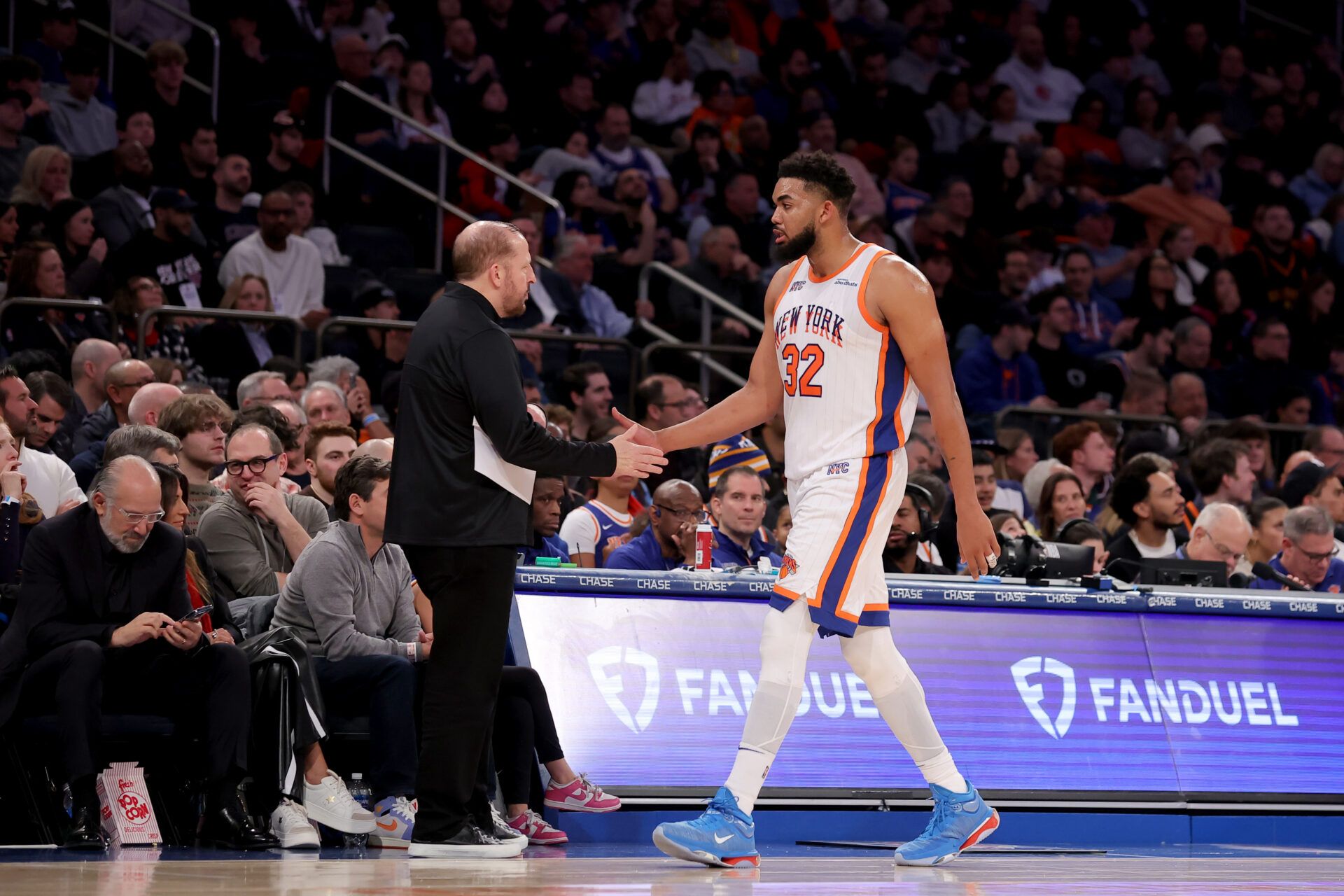 New York Knicks center Karl-Anthony Towns (32) shakes hands with New York Knicks head coach Tom Thibodeau as he exits the game during the third quarter against the Oklahoma City Thunder at Madison Square Garden.