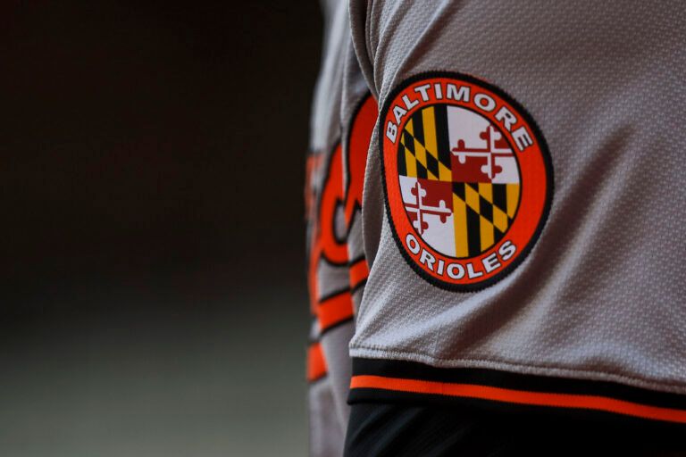 The Baltimore Orioles logo on the sleeve of designated hitter Gunnar Henderson (2) as he prepares on deck during the seventh inning against the Cincinnati Reds at Great American Ball Park.