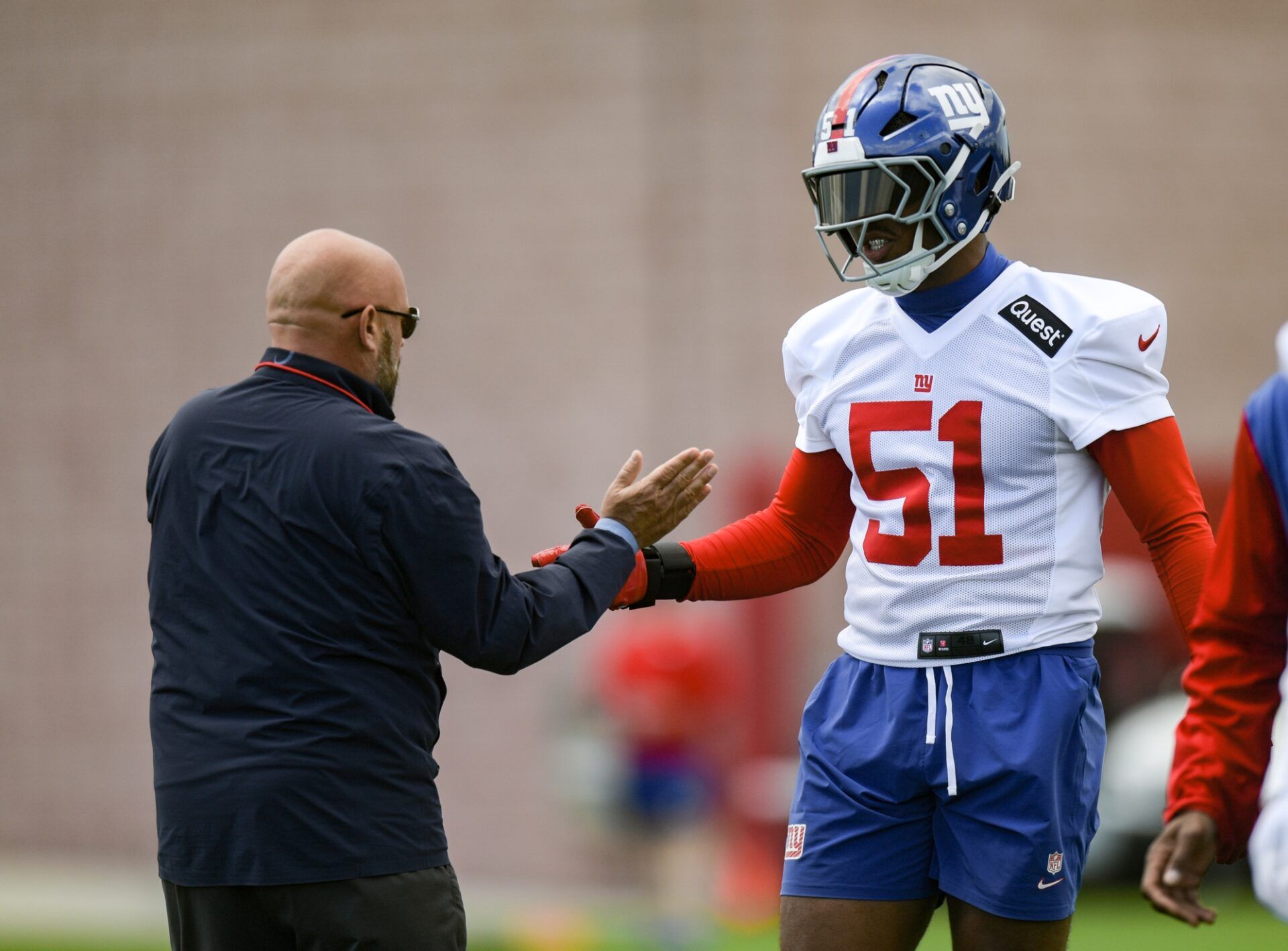New York Giants head coach Brian Daboll greets linebacker Abdul Carter (51) during rookie minicamp at Quest Diagnostics Training Center.
