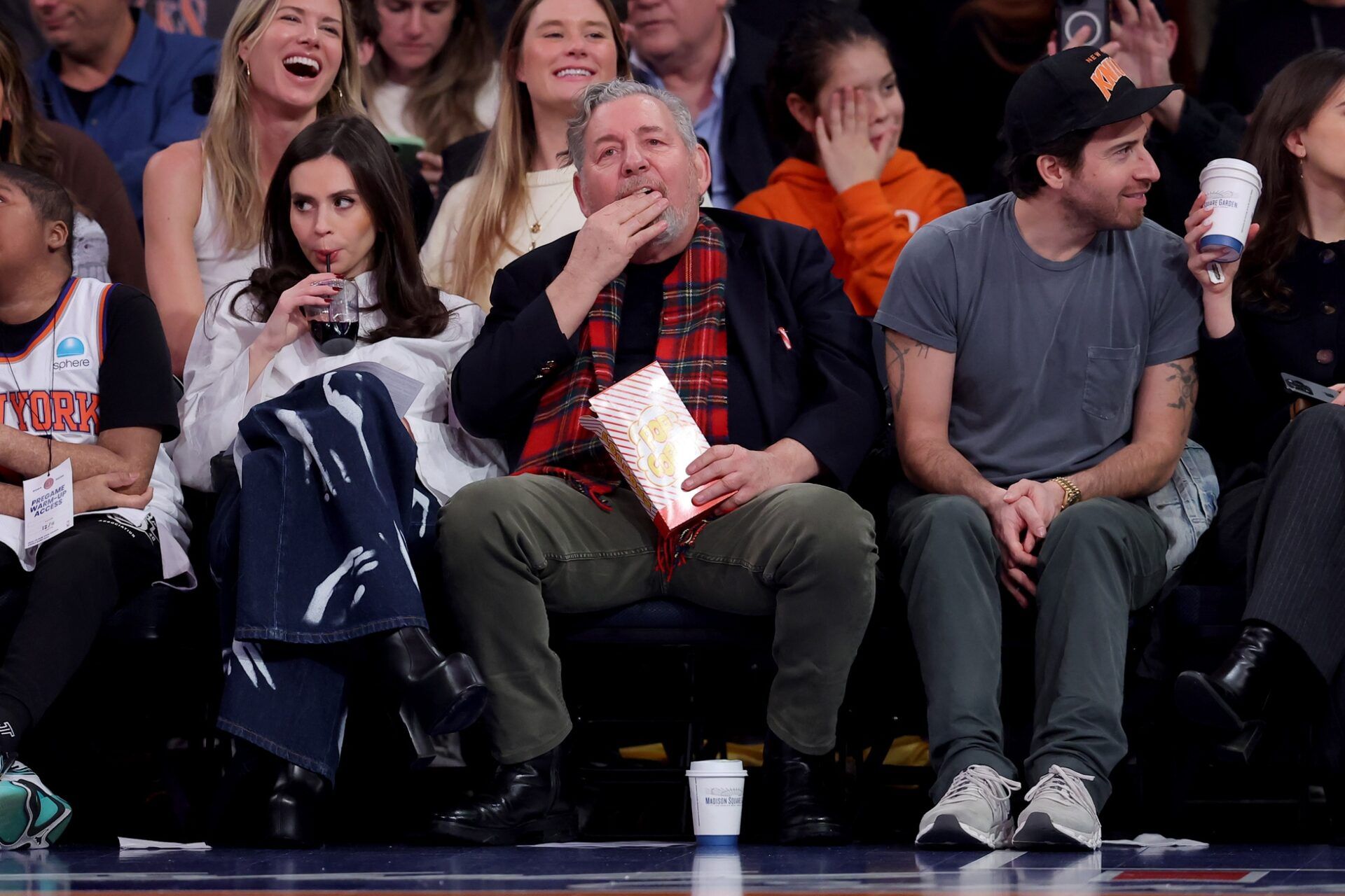 New York Knicks executive chairman James Dolan eats popcorn as he sits court side during the second quarter against the Atlanta Hawks at Madison Square Garden.