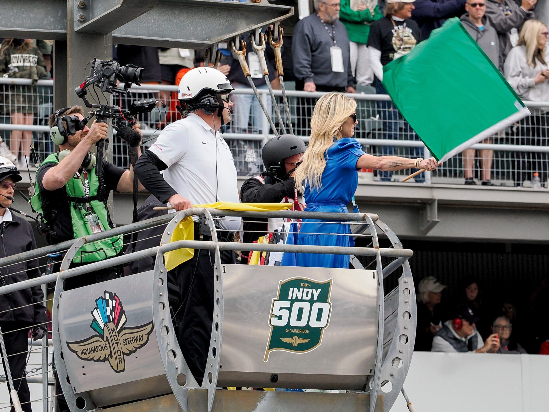 Casey Foyt, the daughter of late Indianapolis Colts owner Jim Irsay, waves the green flag Sunday, May 25, 2025, during the 109th running of the Indianapolis 500 at Indianapolis Motor Speedway.