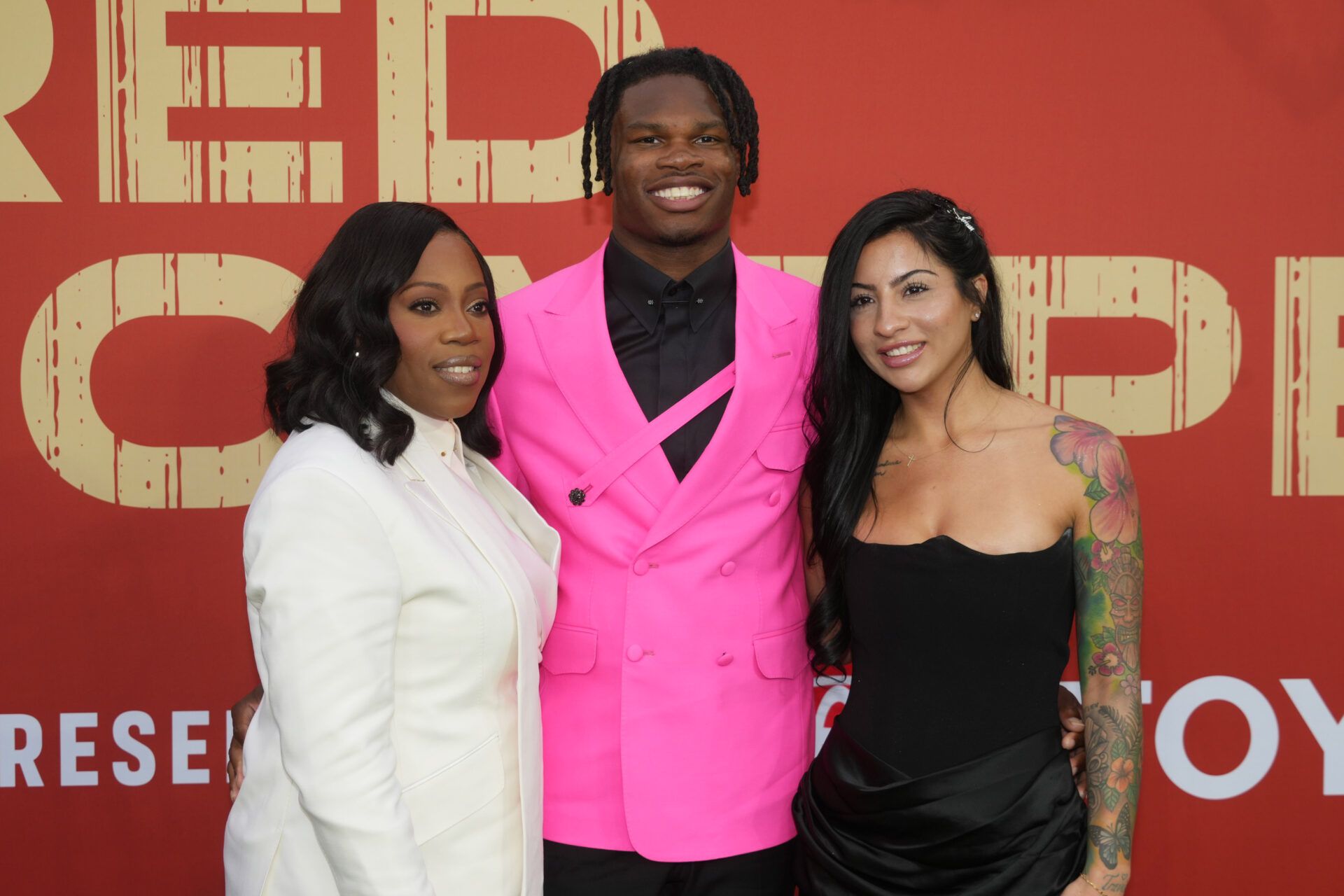 Colorado Buffaloes wide receiver Travis Hunter with his mother Ferrante Harris and his fiancee Leanna Lenee on the red carpet before the 2025 NFL Draft at Lambeau Field.
