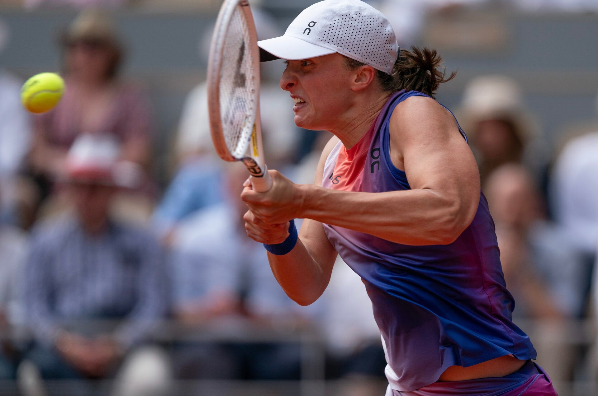 Iga Swiatek of Poland returns a shot during her match against Jasmine Paolini of Italy on day 14 of Roland Garros at Stade Roland Garros.