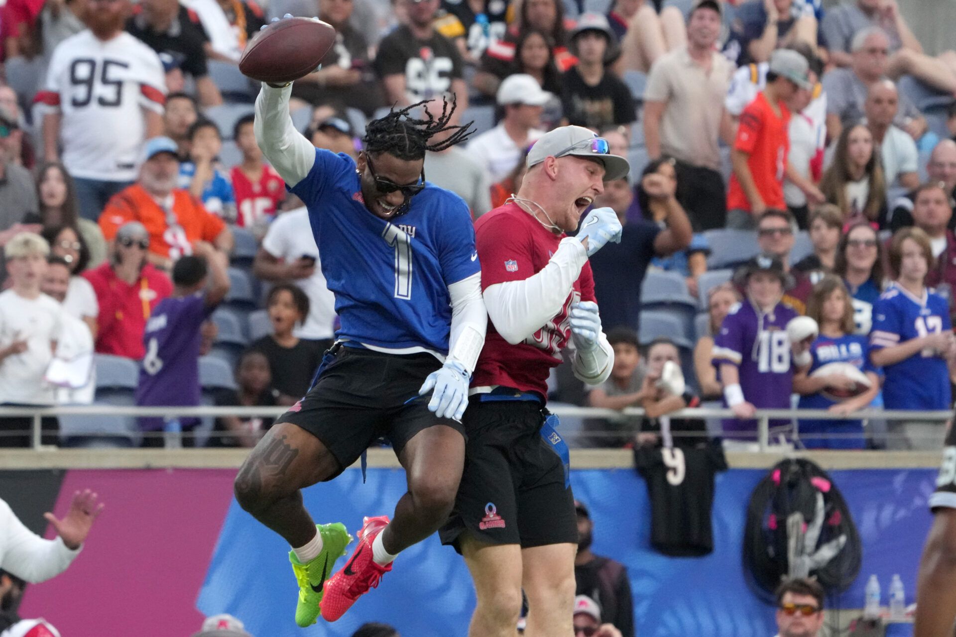 NFC receiver Malik Navers of the New York Gaints (1) and tight end Trey McBride of the Arizona Cardinals (85) celebrate after a touchdown during the 2025 Pro Bowl Games at Camping World Stadium.